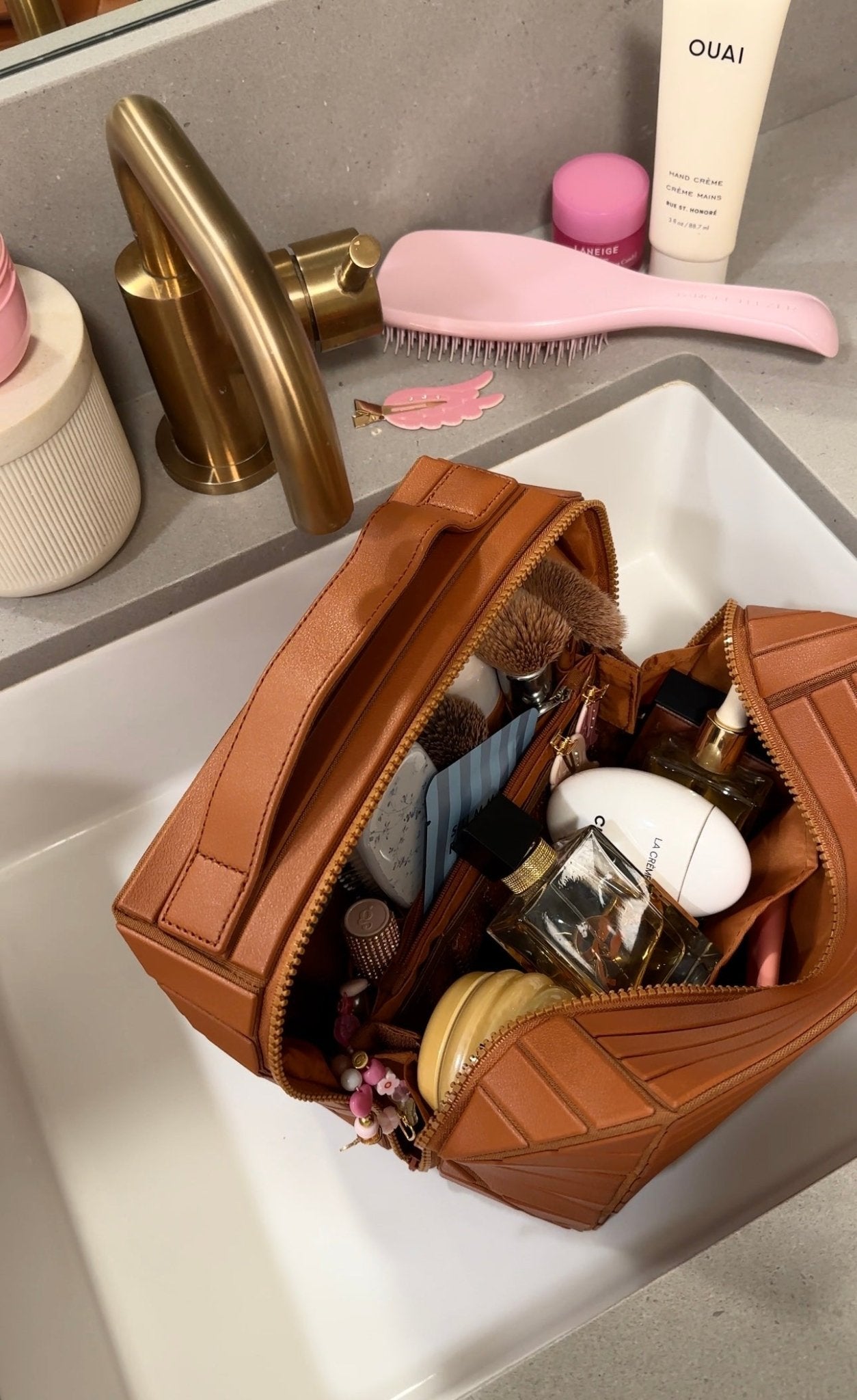 Mocha brown XL case with dual zippers, open front showing makeup tools and bottles