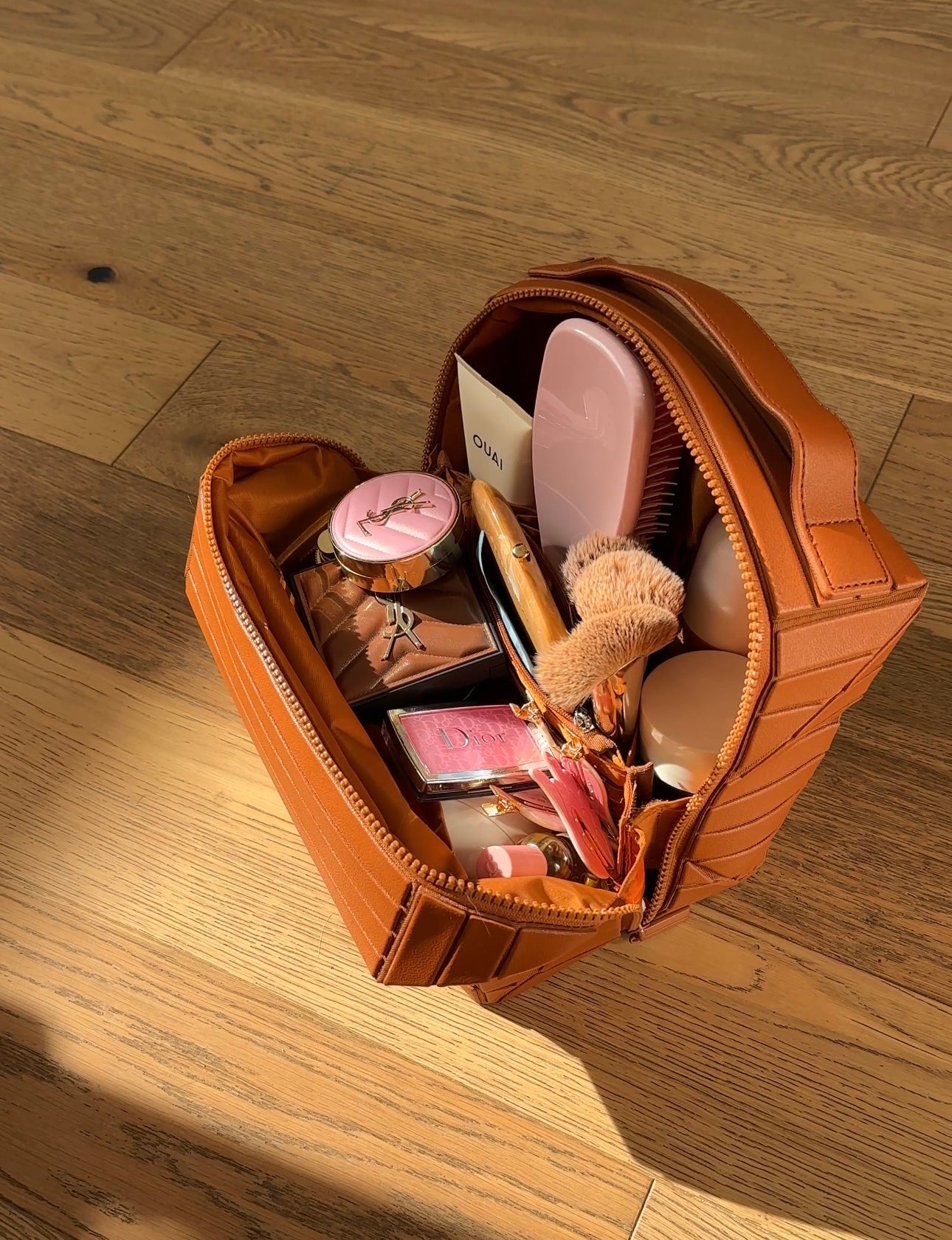 Mocha-brown XL cosmetic case open, showing brushes, compacts, and small bottles inside