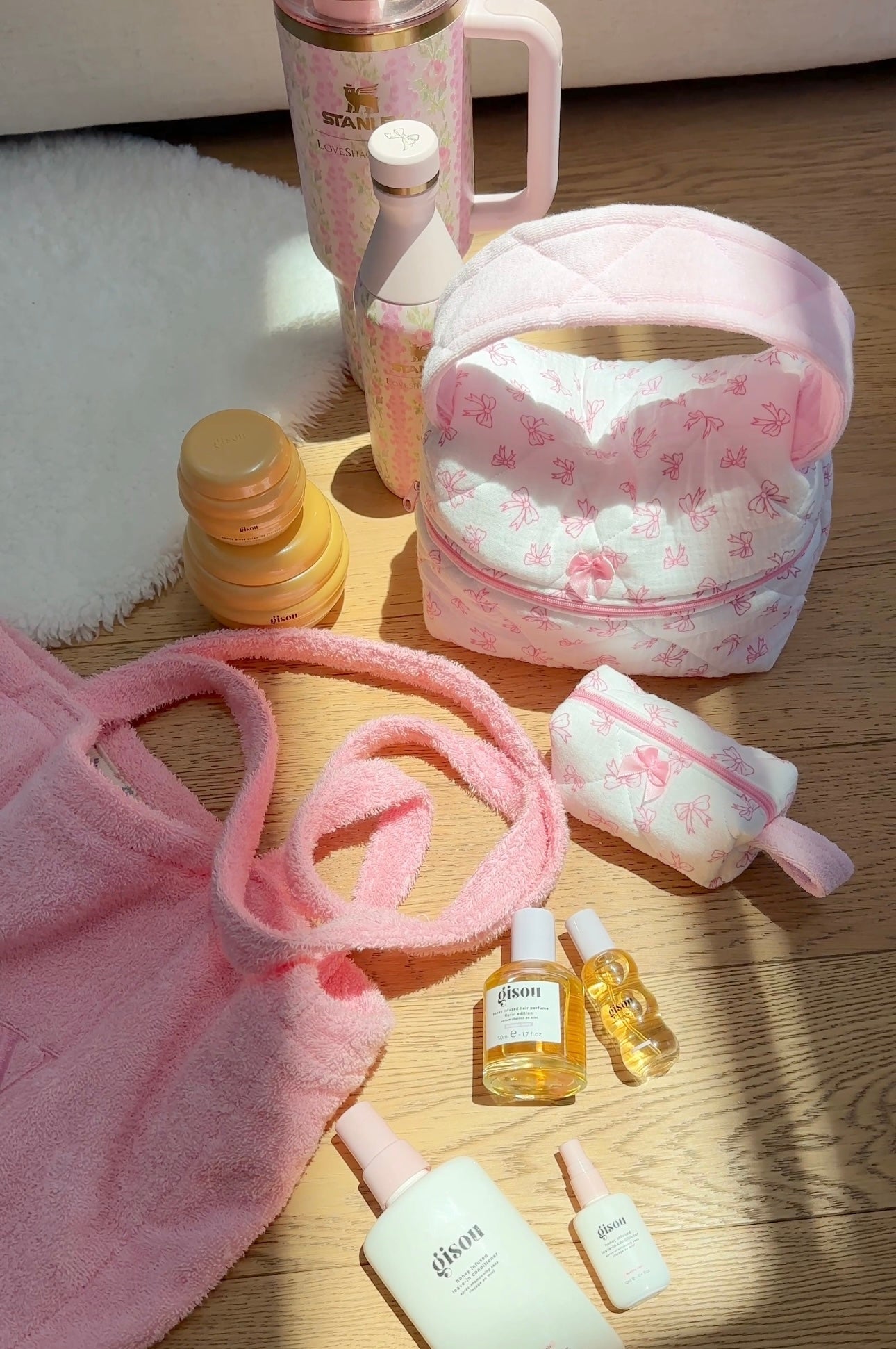 Pink patterned handbag set with arched handle and fuzzy trim; zip-top pouch