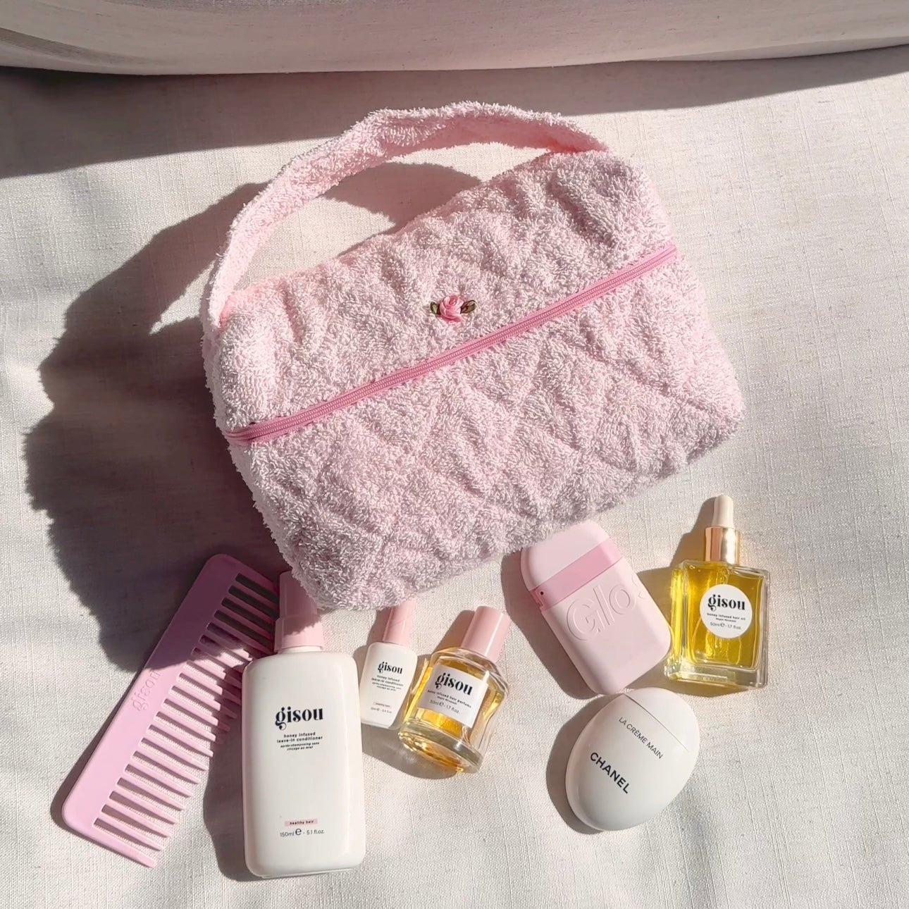 Baby pink teddy handbag with curved top handle, front zipper track, rose charm