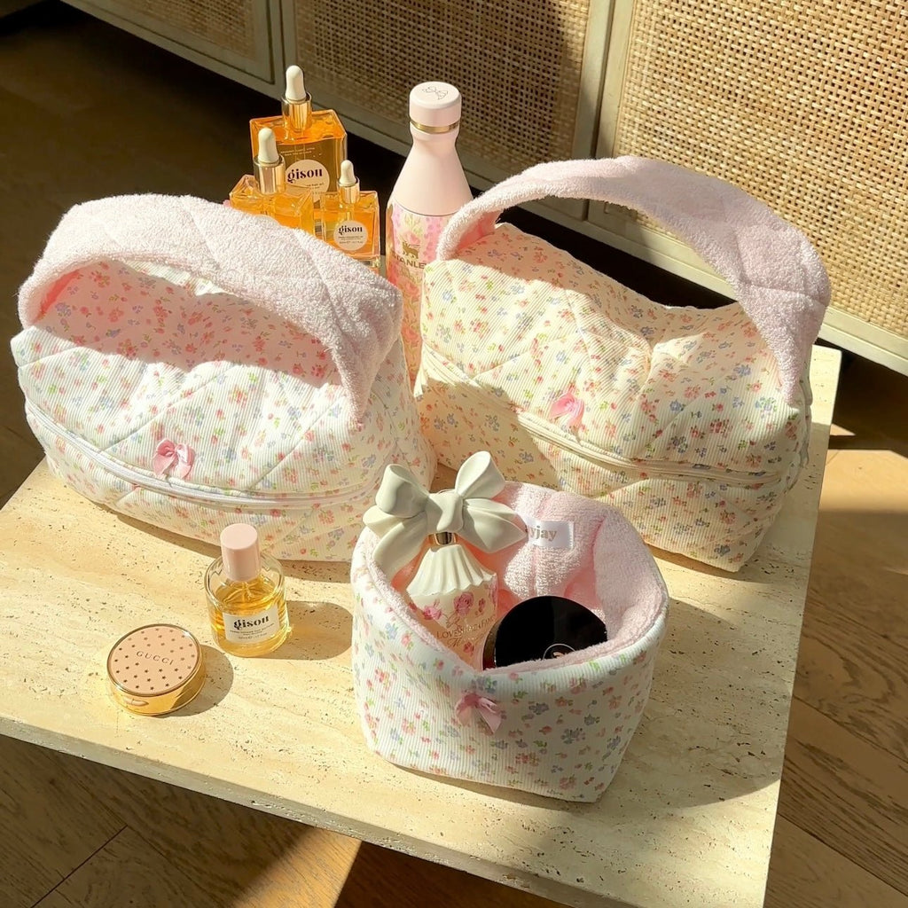 Floral handbag trio: pink-pastel patterned bags with arched handles and zip tops