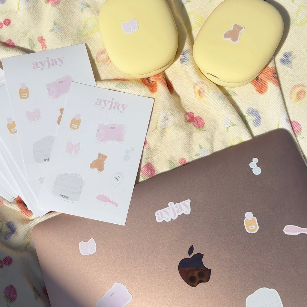 Sticker sheet with pastel icons: butterfly, bear, bottle, and heart designs