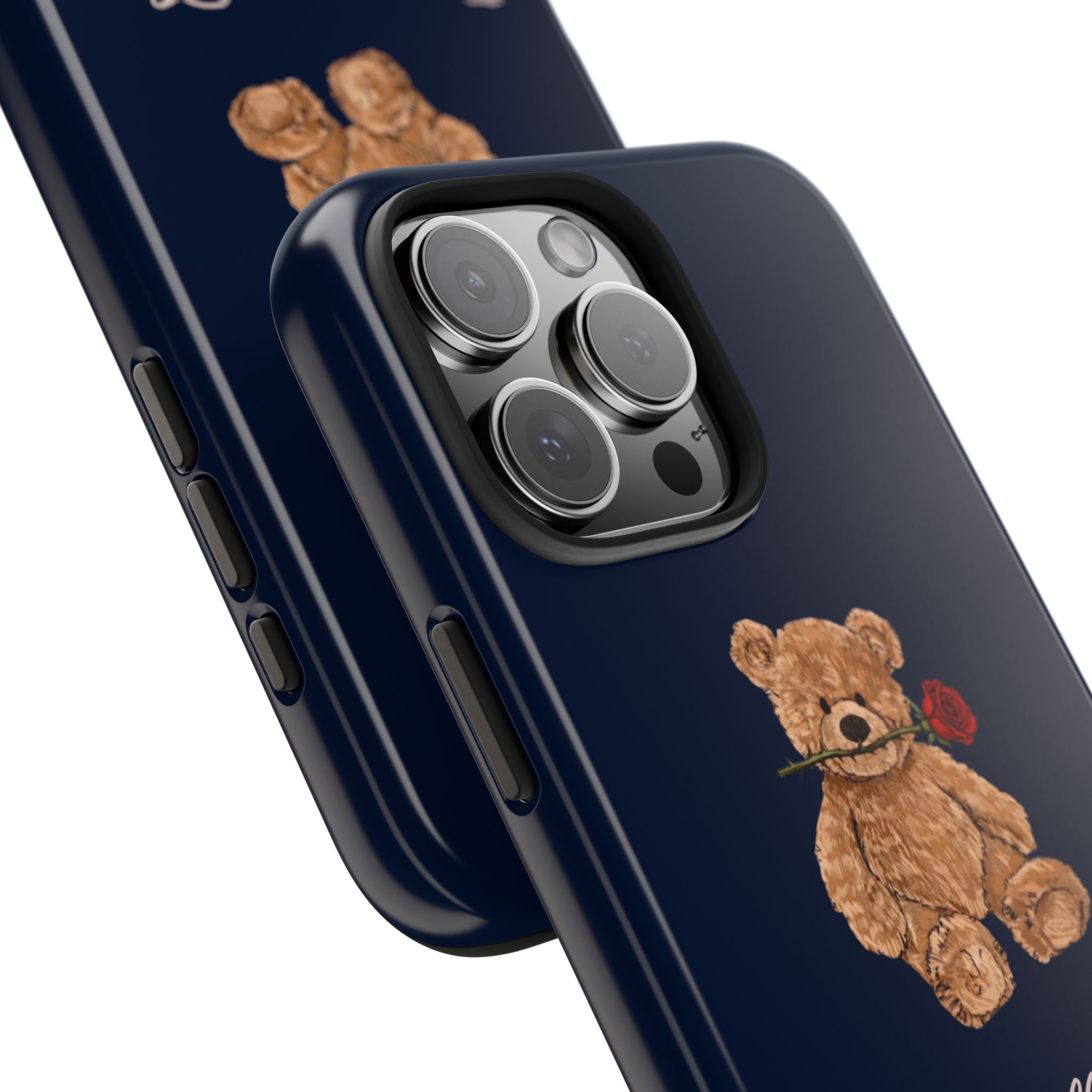 Angled dark blue phone case with teddy bear and red rose near camera cutout