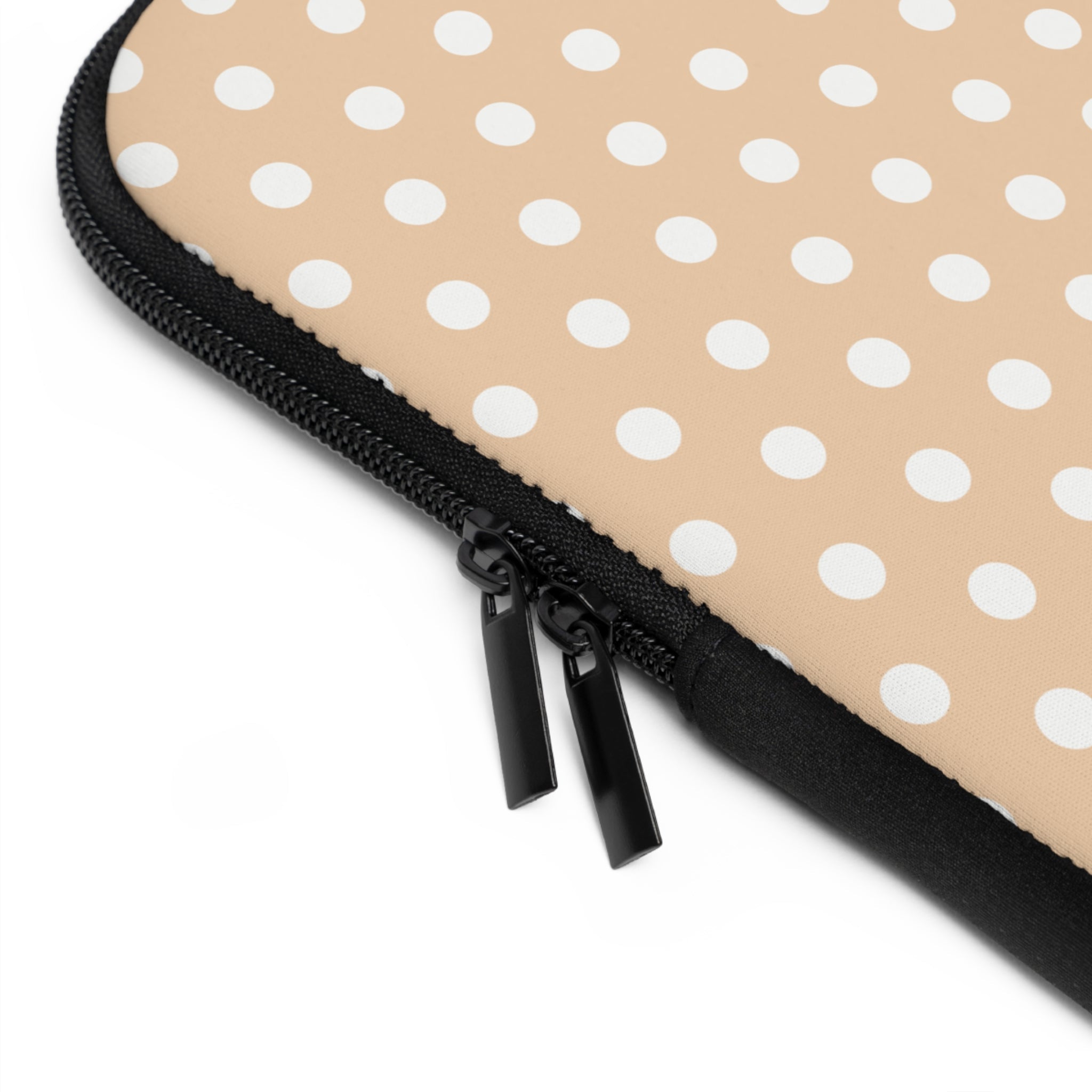 Close-up of black zipper on vanilla polka dot neoprene sleeve