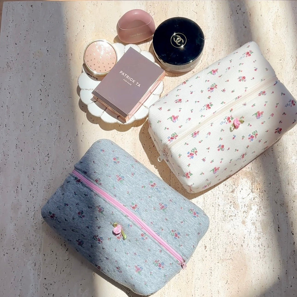 Beige floral zip pouch and blue floral zip pouch set, both with zipper and small blossoms