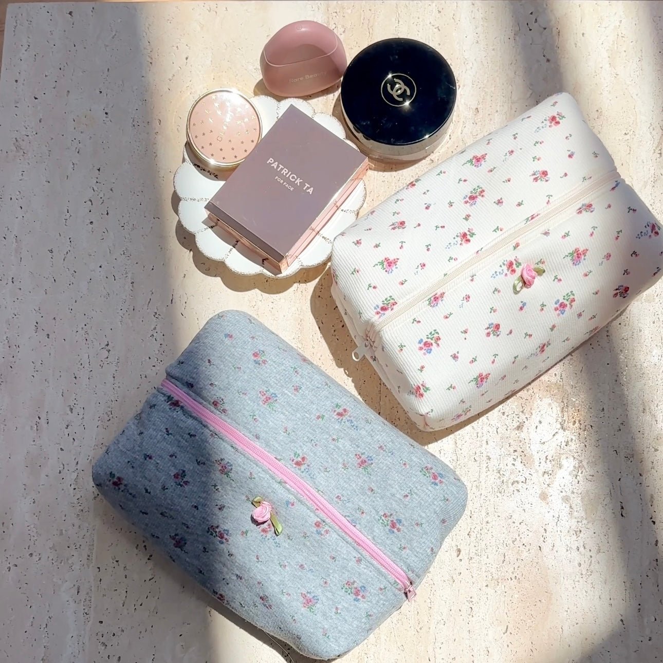 Beige floral zip pouch and blue floral zip pouch set, both with zipper and small blossoms