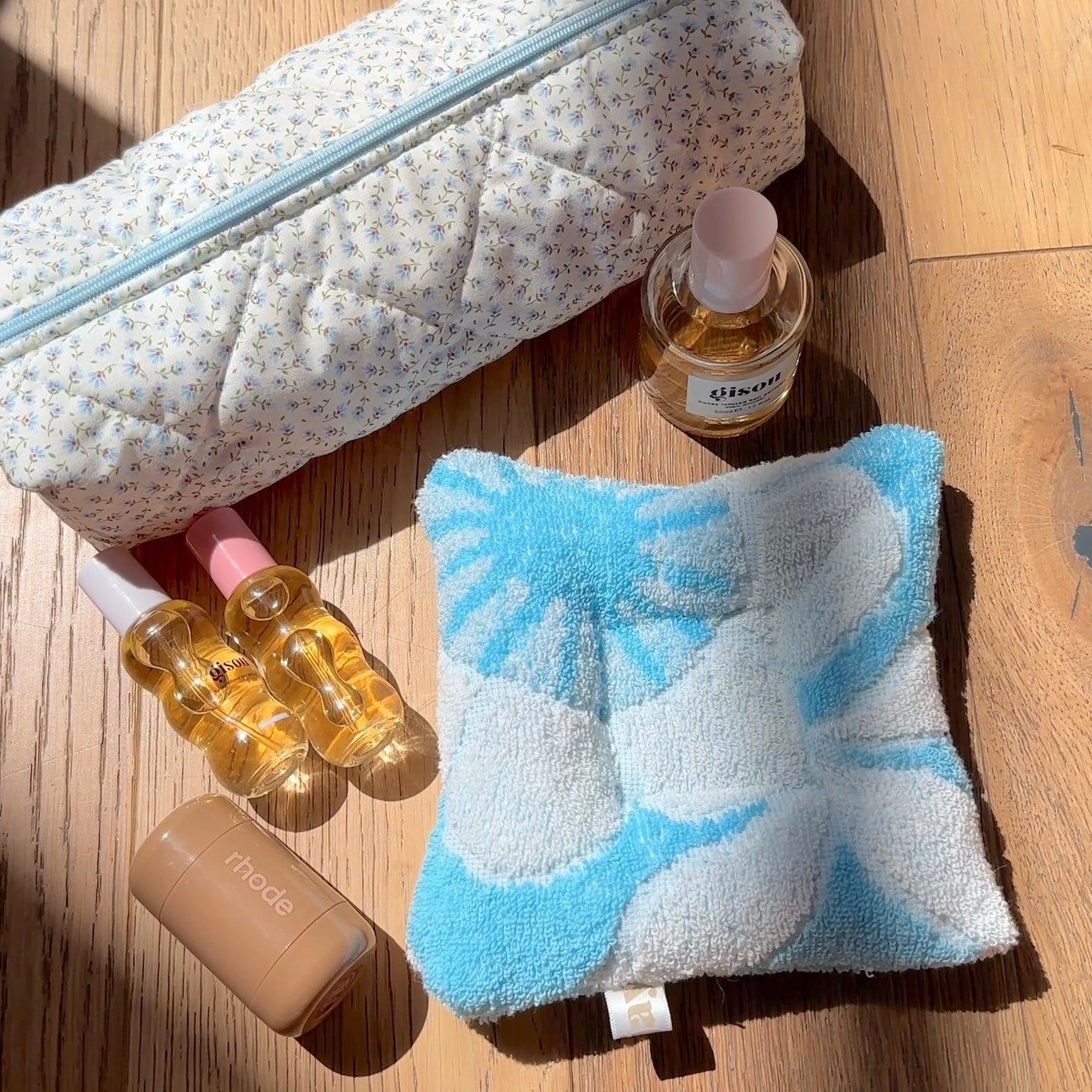 Light blue plush square coaster with white and blue cloud pattern