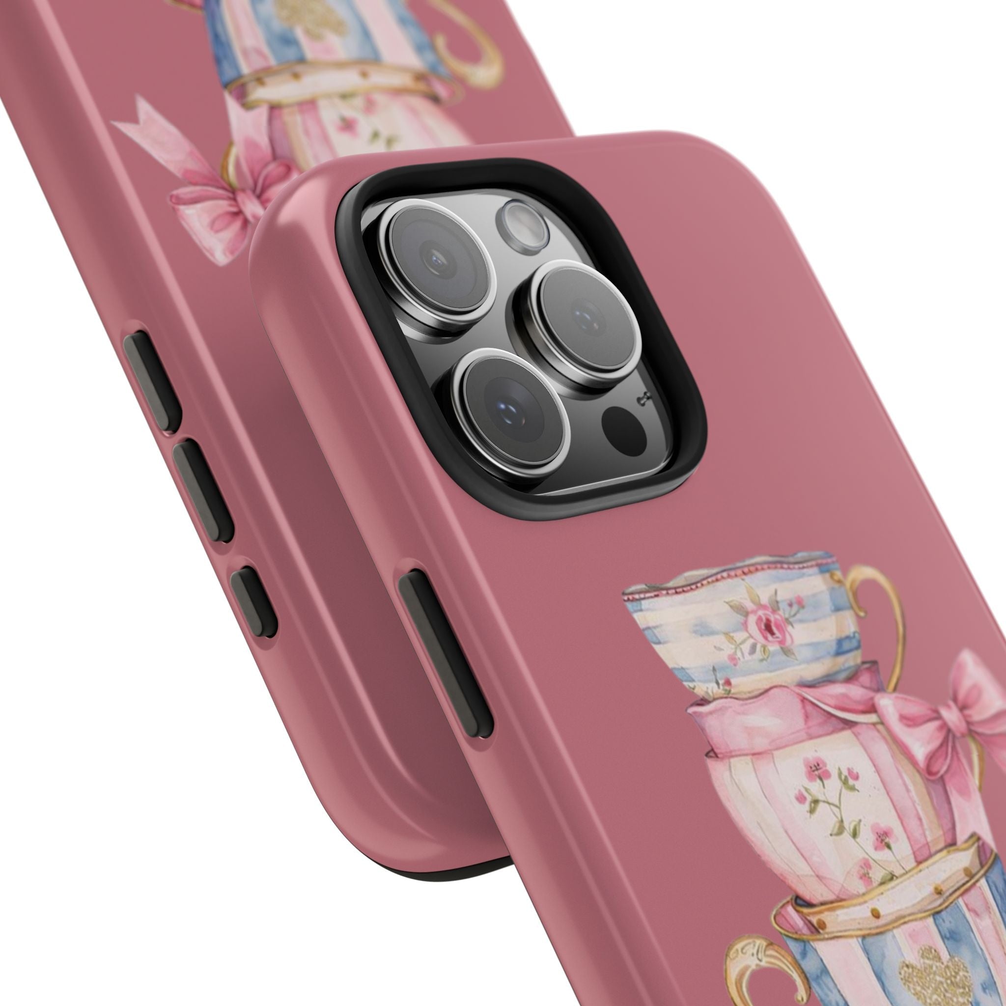 Angled pink phone case showing camera lenses and vintage teacup graphic near bottom