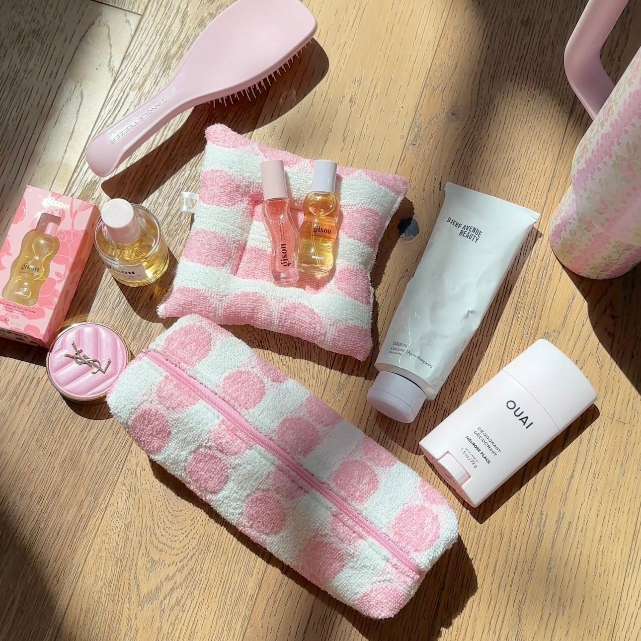 Pink-and-white check zip pouch with matching towel, alongside bath accessories