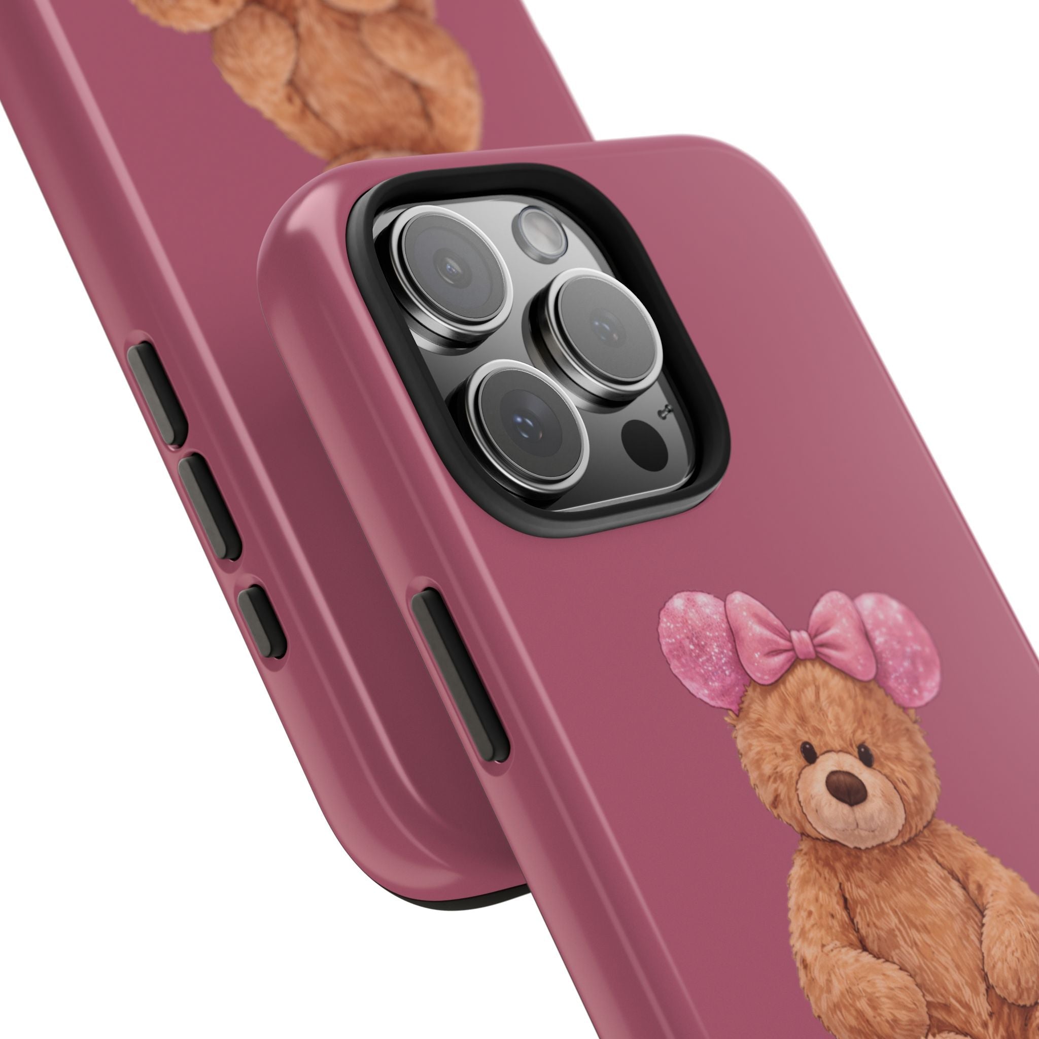 Pink phone case close-up: teddy bear and bow near camera cutout