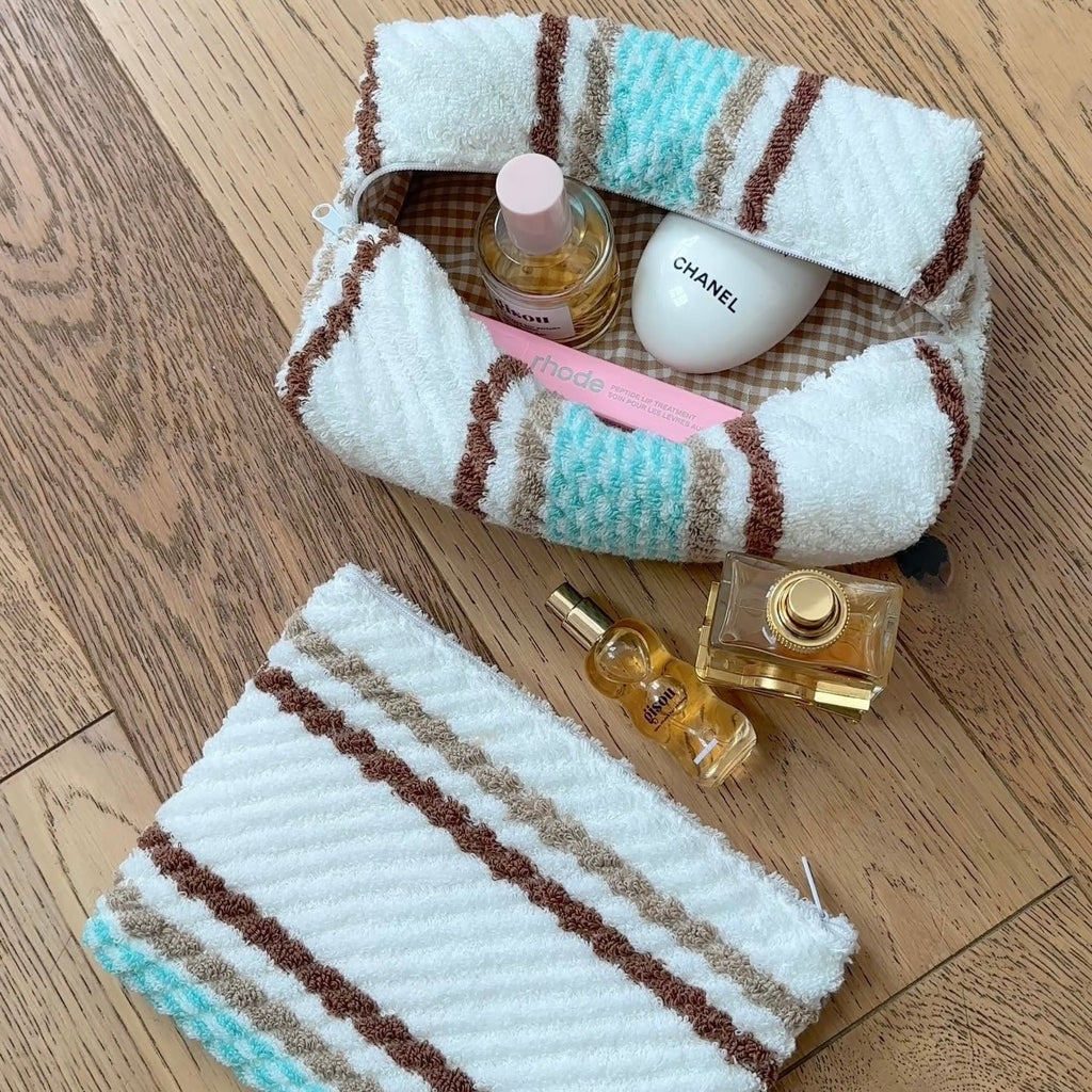 White terry towelling with brown and blue stripe bands, folded roll