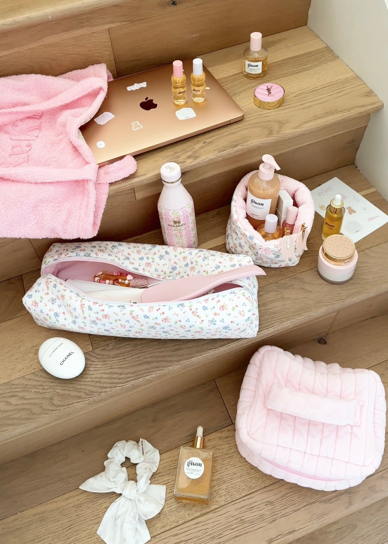 White floral zip pouch on shelf, partially open with pink lining
