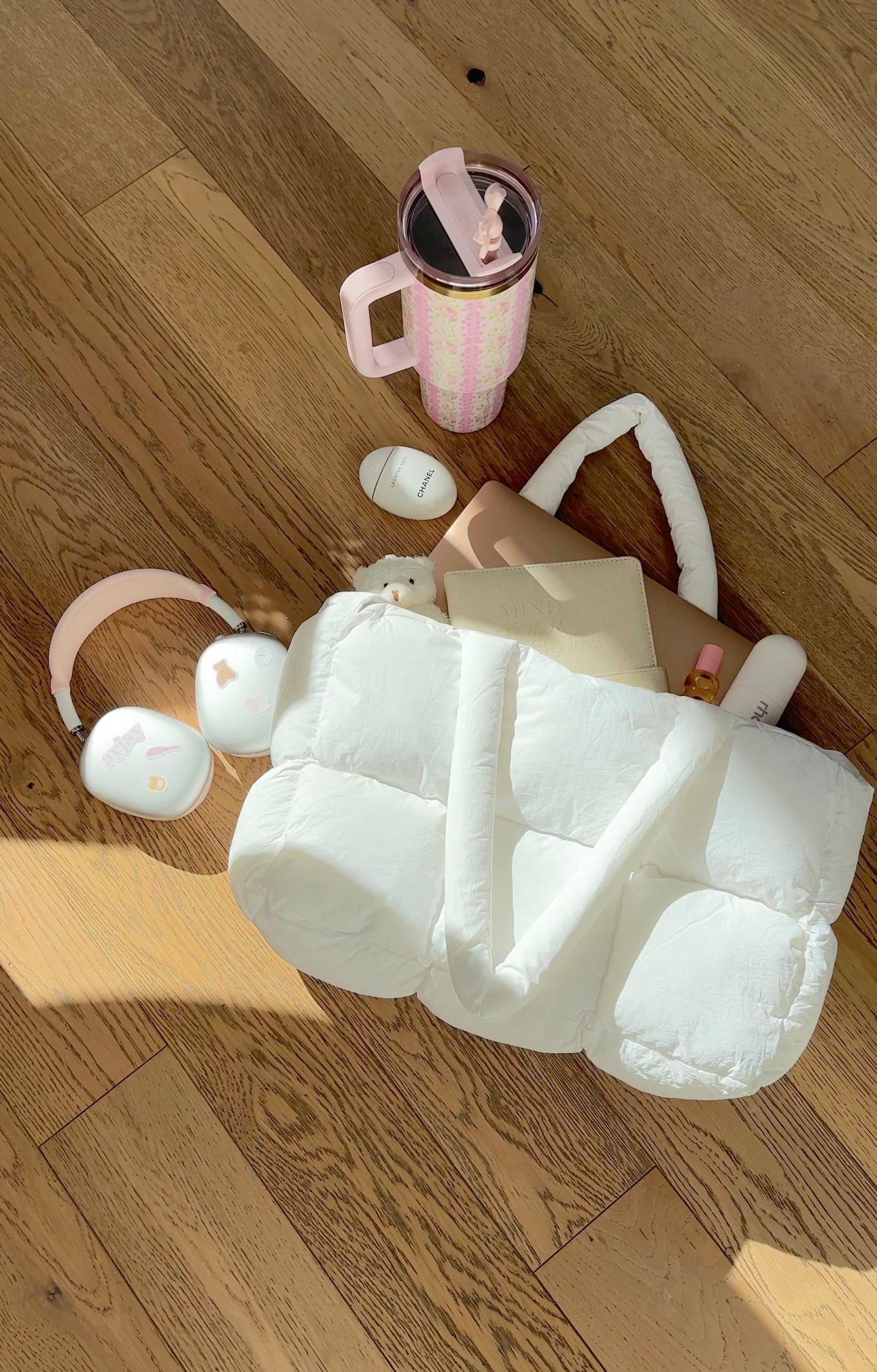 White quilted puffer duffle bag with loop handles, laid open