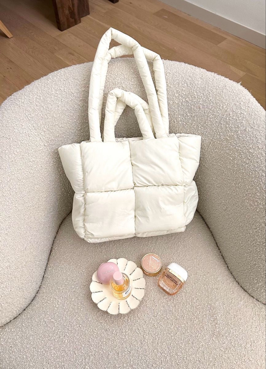 Cream quilted puffer tote bag with short top handles and square shape