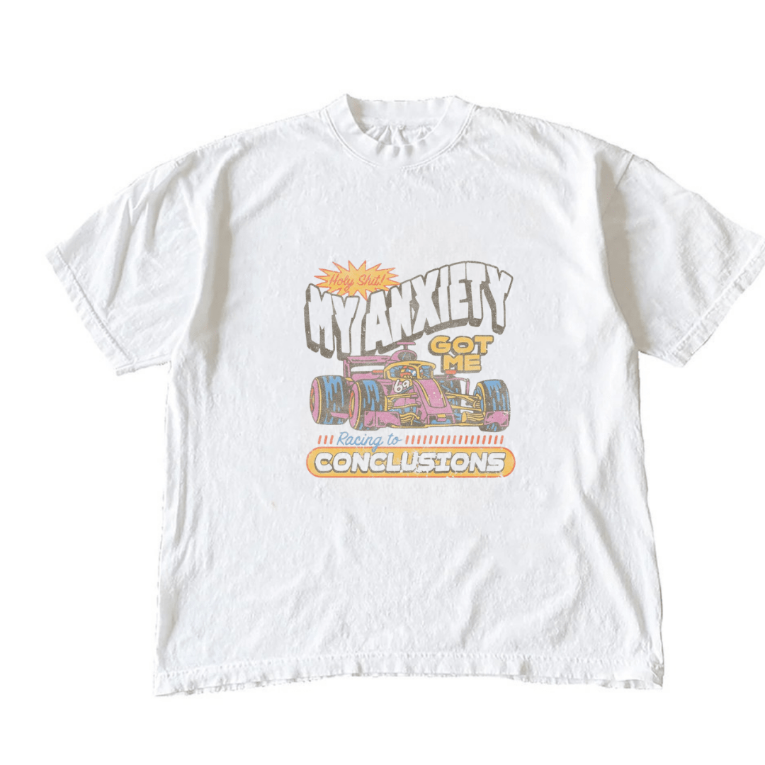 White graphic T-shirt with racing to conclusions typography and illustrated car scene