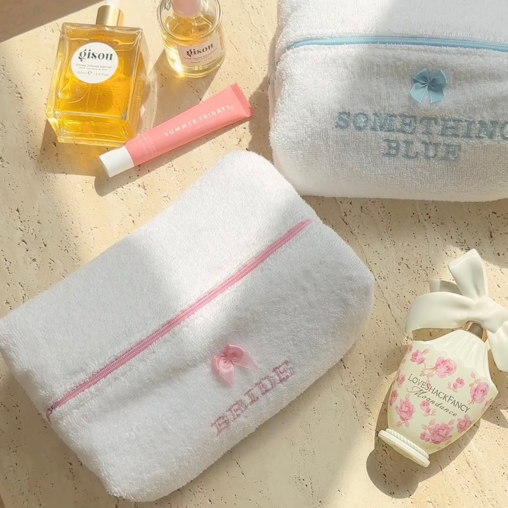 White plush zip pouch with pink zipper, embroidered teddy bride detail