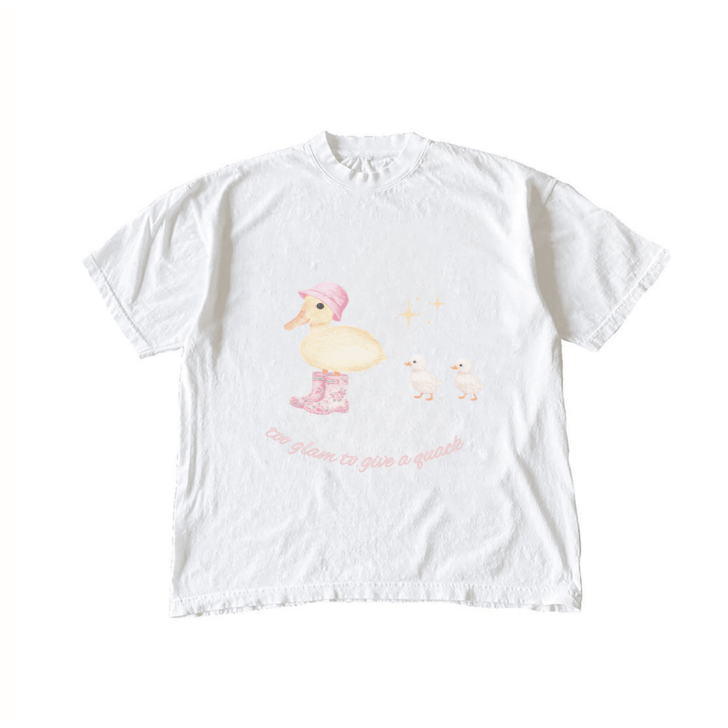 White graphic T-shirt with pink hat duck, two chicks, and glittery text