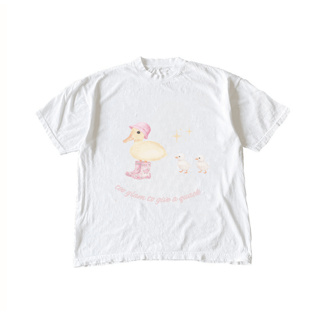 White graphic T-shirt with pink hat duck, two chicks, and glittery text