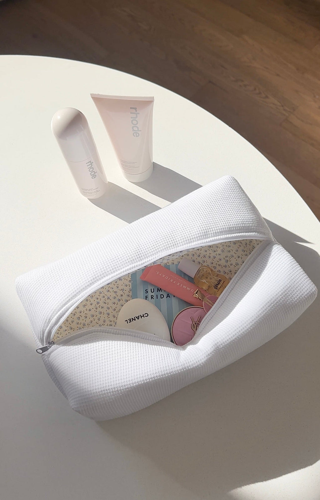 White waffle-knit zip pouch open, rounded shape, zipper closure visible