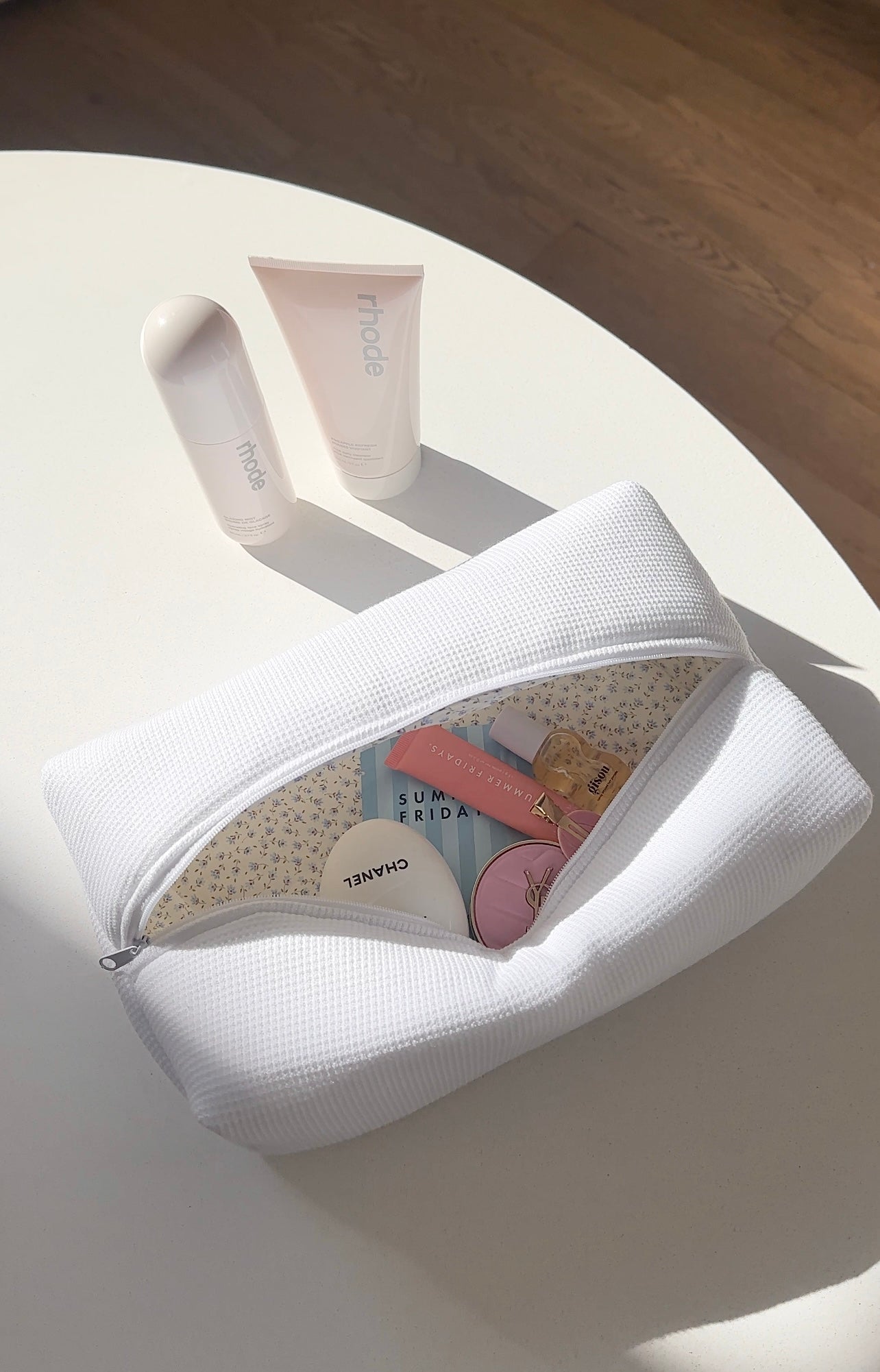 White waffle-knit zip pouch open, rounded shape, zipper closure visible