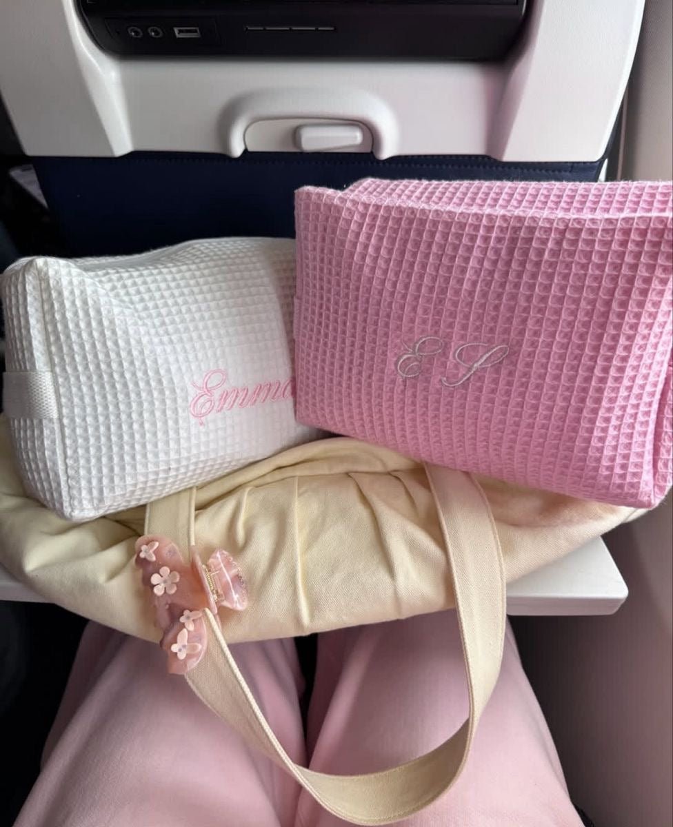 White waffle-knit and pink waffle-knit embroidered bags with name-style script