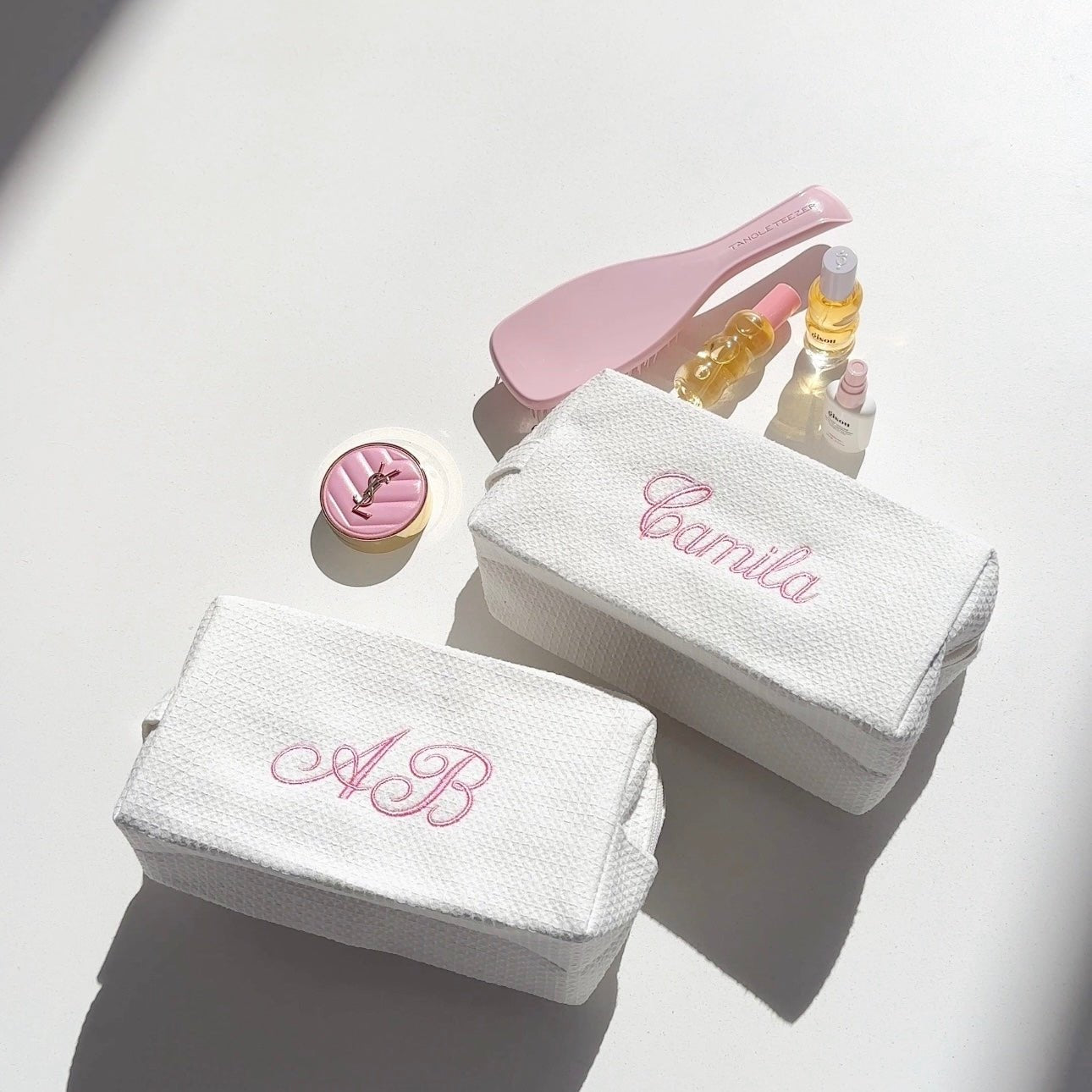 White waffle-knit custom embroidery bag with pink script initials, zip-top style