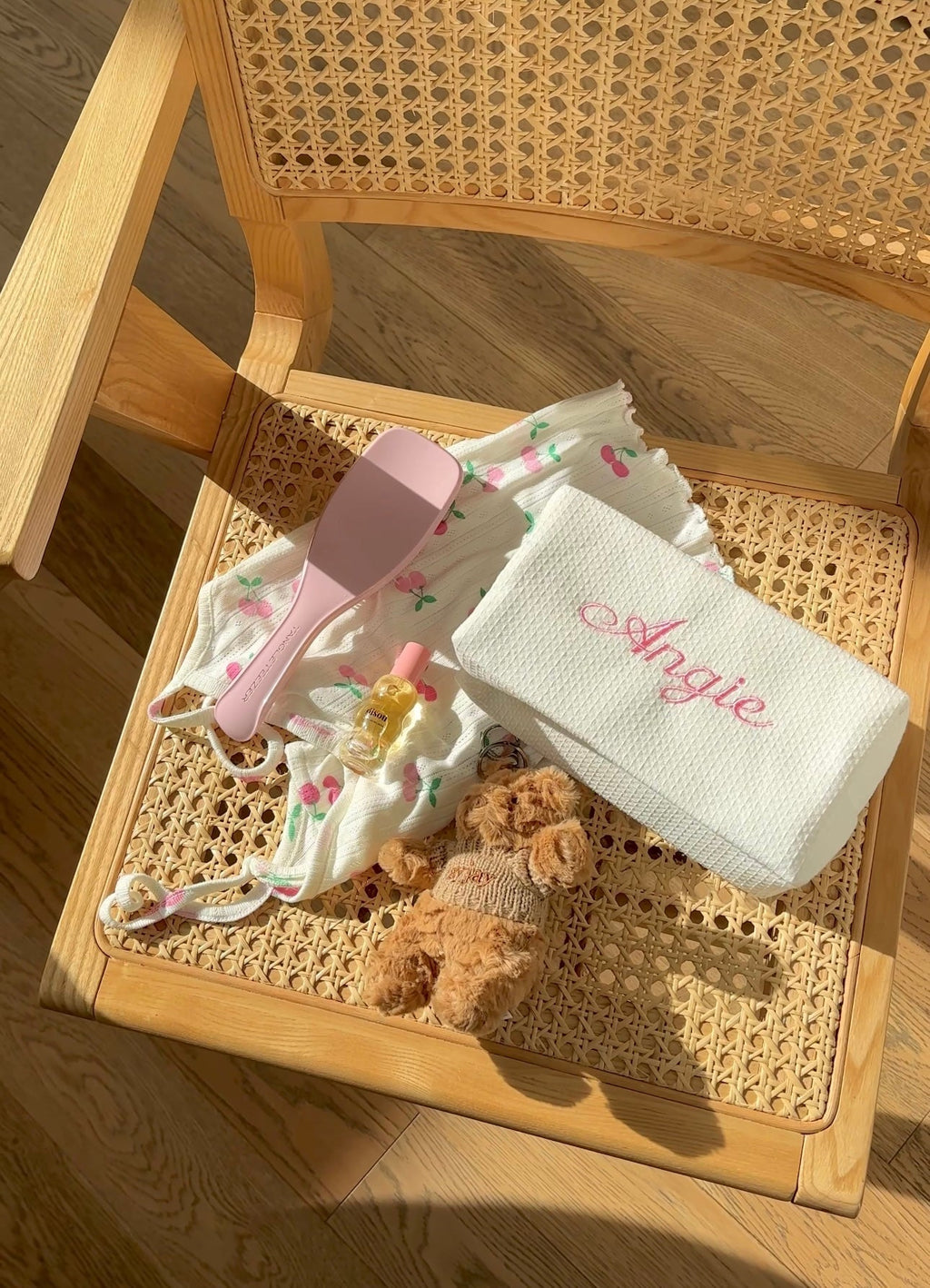 White waffle-knit custom embroidery bag with embroidered name on folded white clutch