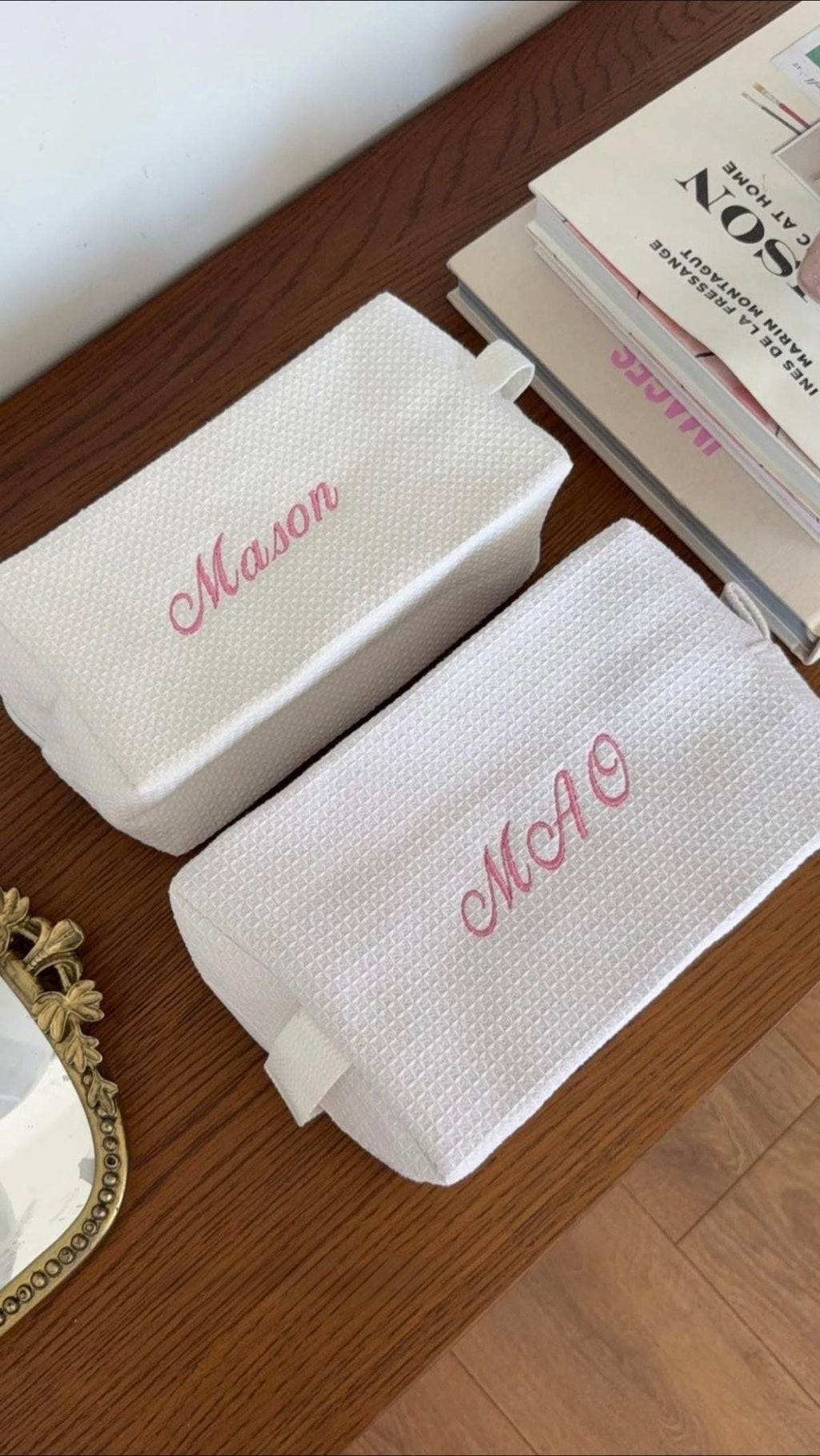 Two white waffle-knit custom embroidery bags with pink name embroidery and handle tab