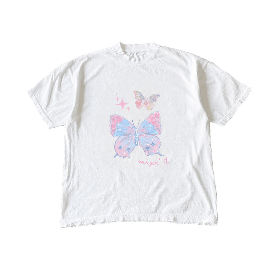 White butterfly T-shirt with pink-blue graphic and 'wingin it' text on front