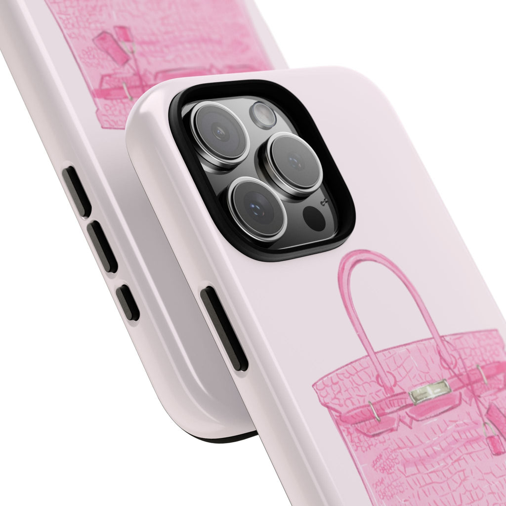 Pink phone case angled close-up showing camera cutout and handbag graphic