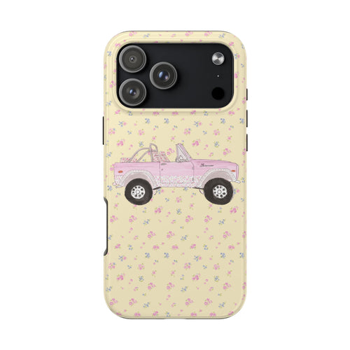 Yellow phone case with ditsy floral print and pink vintage truck illustration; camera cutouts