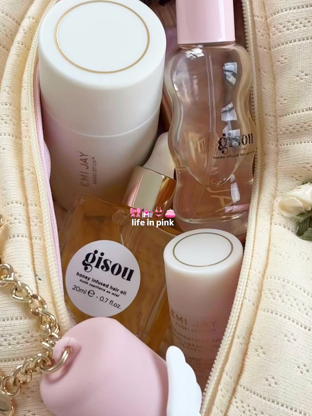 Light yellow lace knit zip pouch open with skincare bottles and pump containers inside