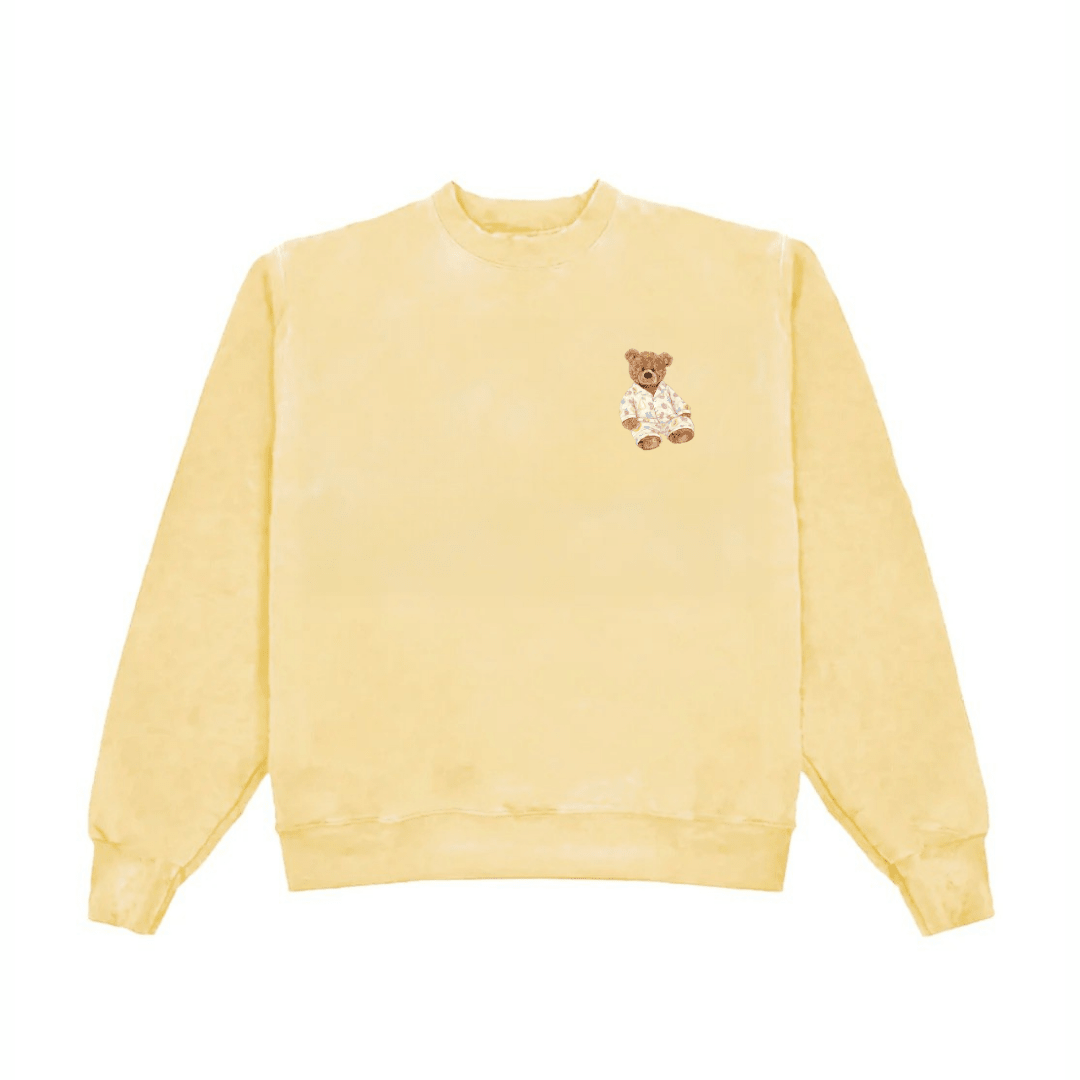Yellow crewneck sweatshirt with small teddy bear graphic at chest