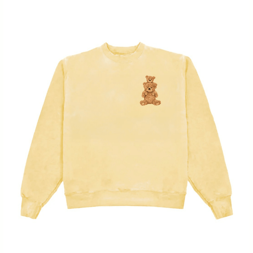 Light yellow crewneck sweatshirt with teddy bear graphic centered on the front