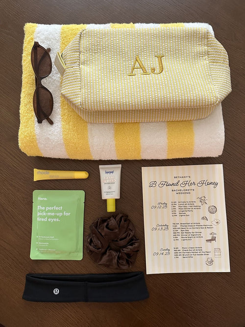 Cream bag with yellow stripes and AJ monogram embroidery.