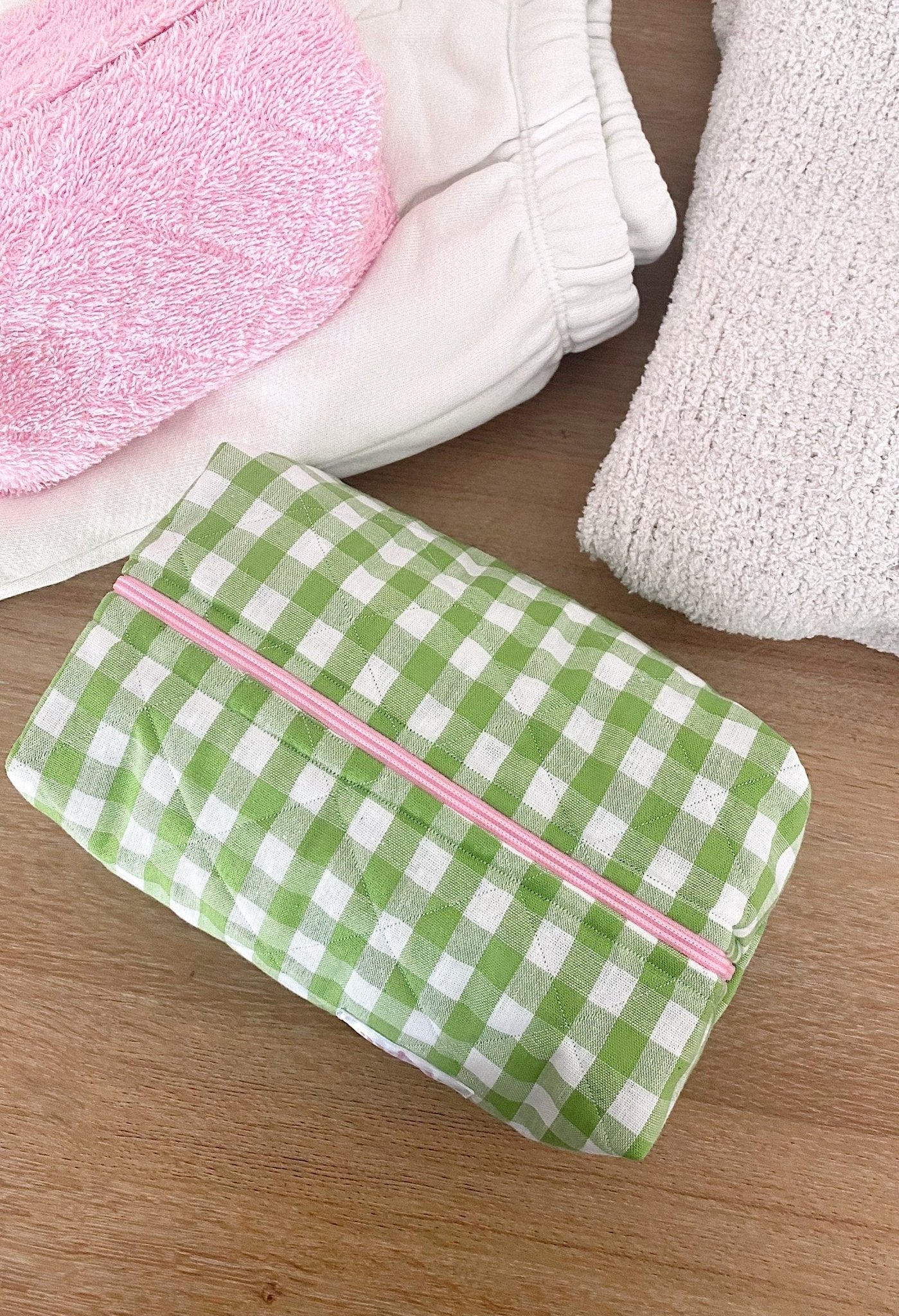 Green gingham pouch with pink zipper stripe, closed