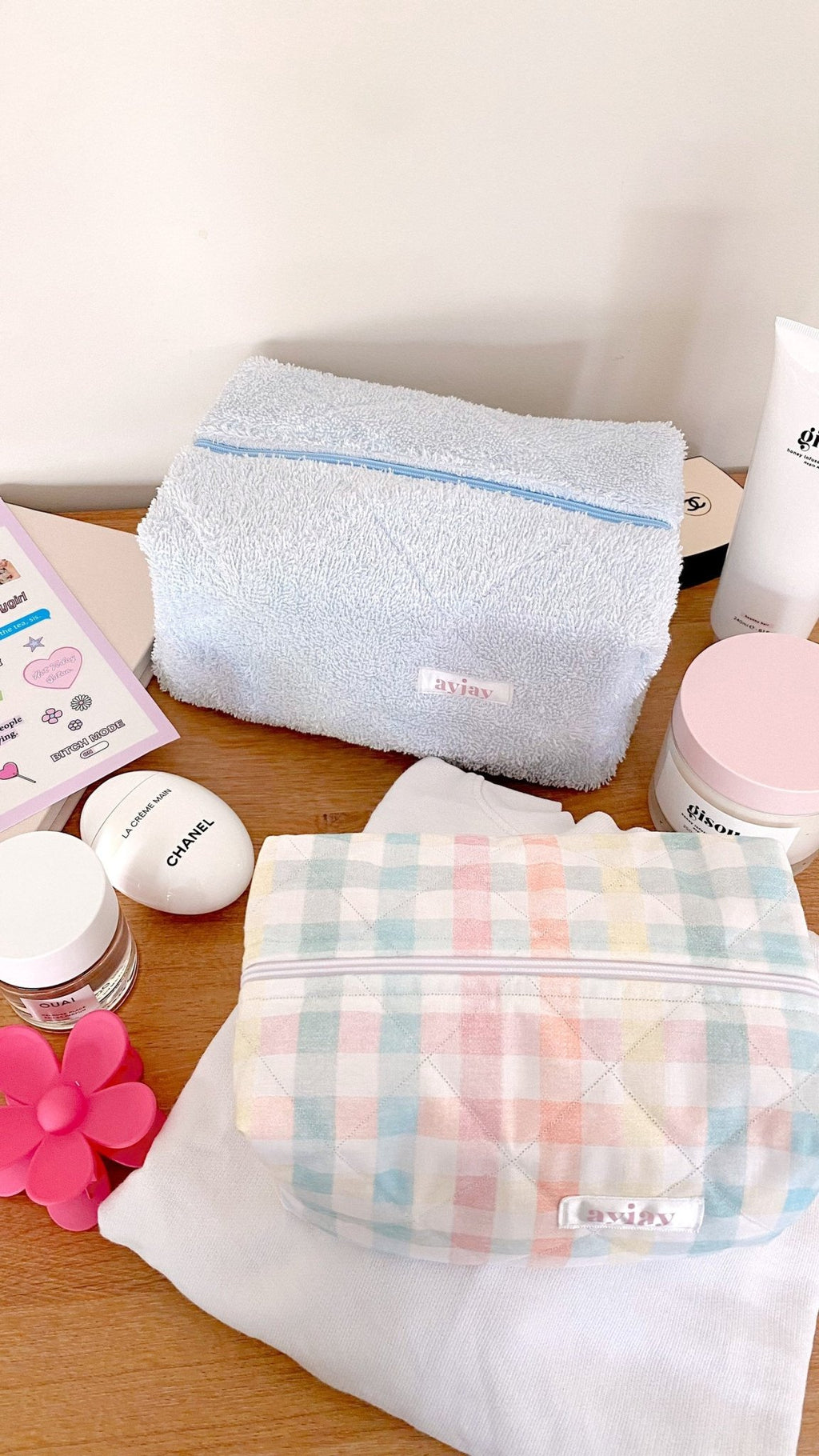 Baby blue terrycloth rectangular pouch with zip, near pastel gingham pouch