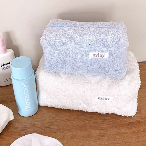Baby blue terrycloth pouch, front zip top and stitched logo patch