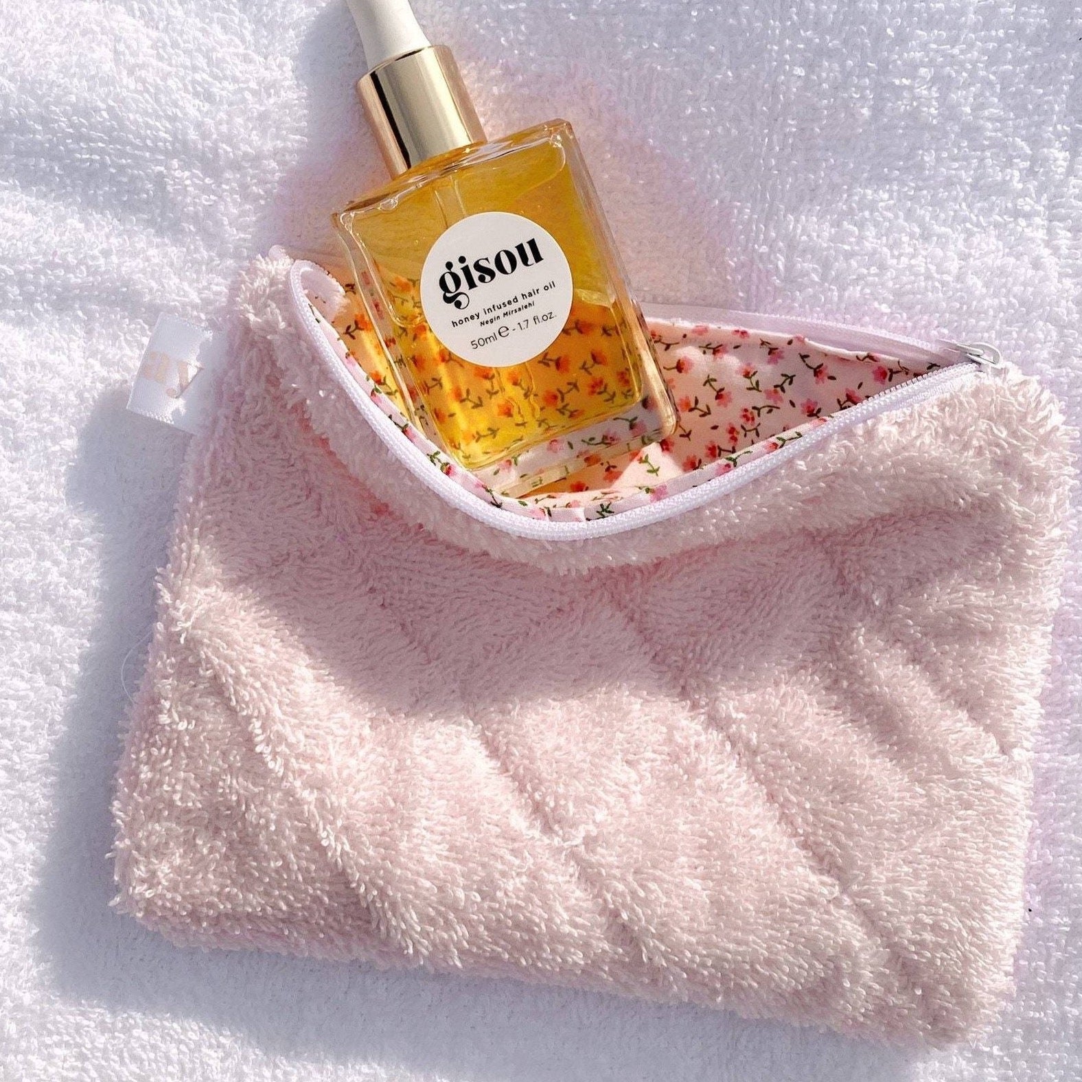 Baby pink teddy flat pouch with white zipper; floral-lined interior shown