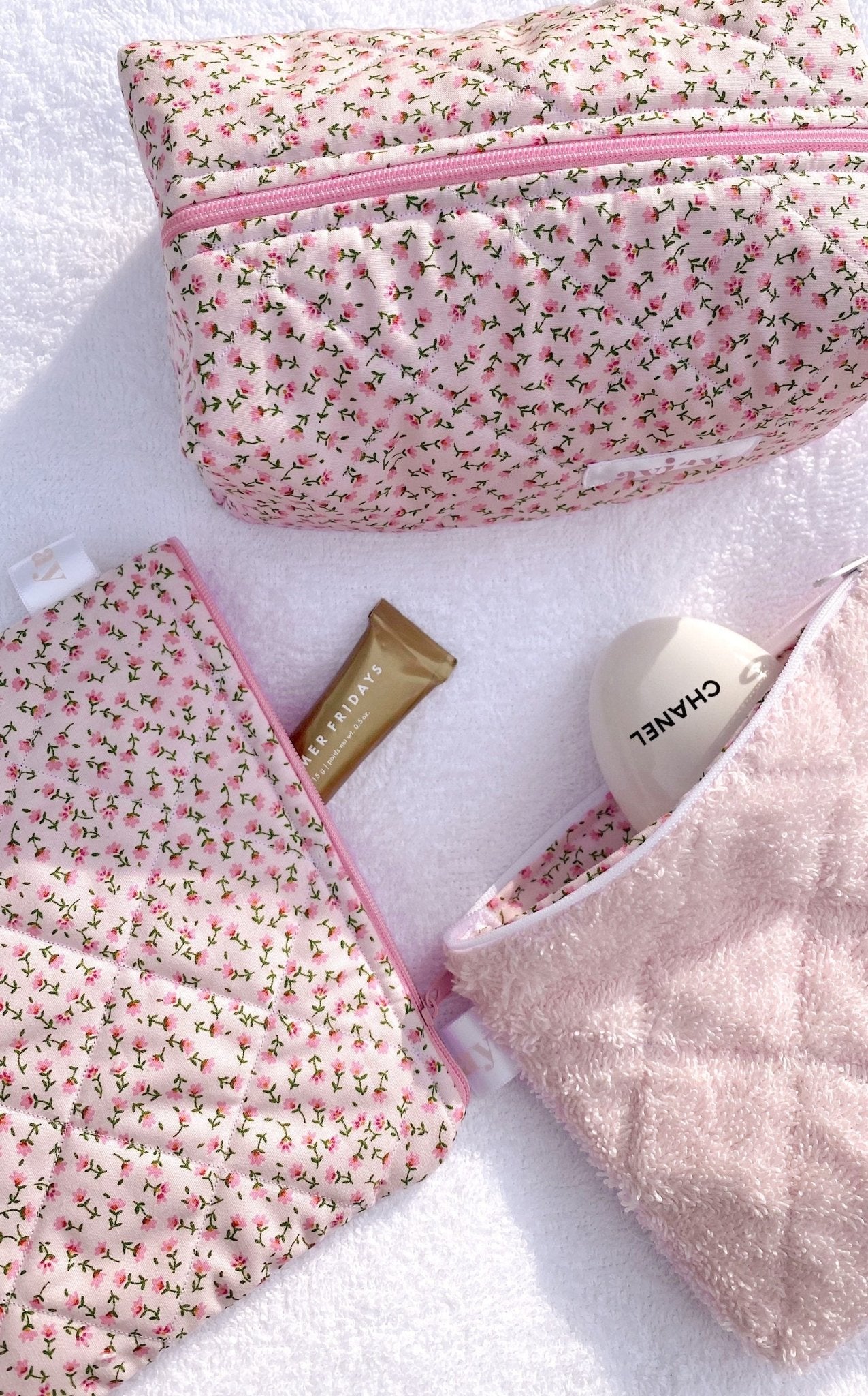 Baby pink teddy pouch with floral fabric and pink zipper; side view