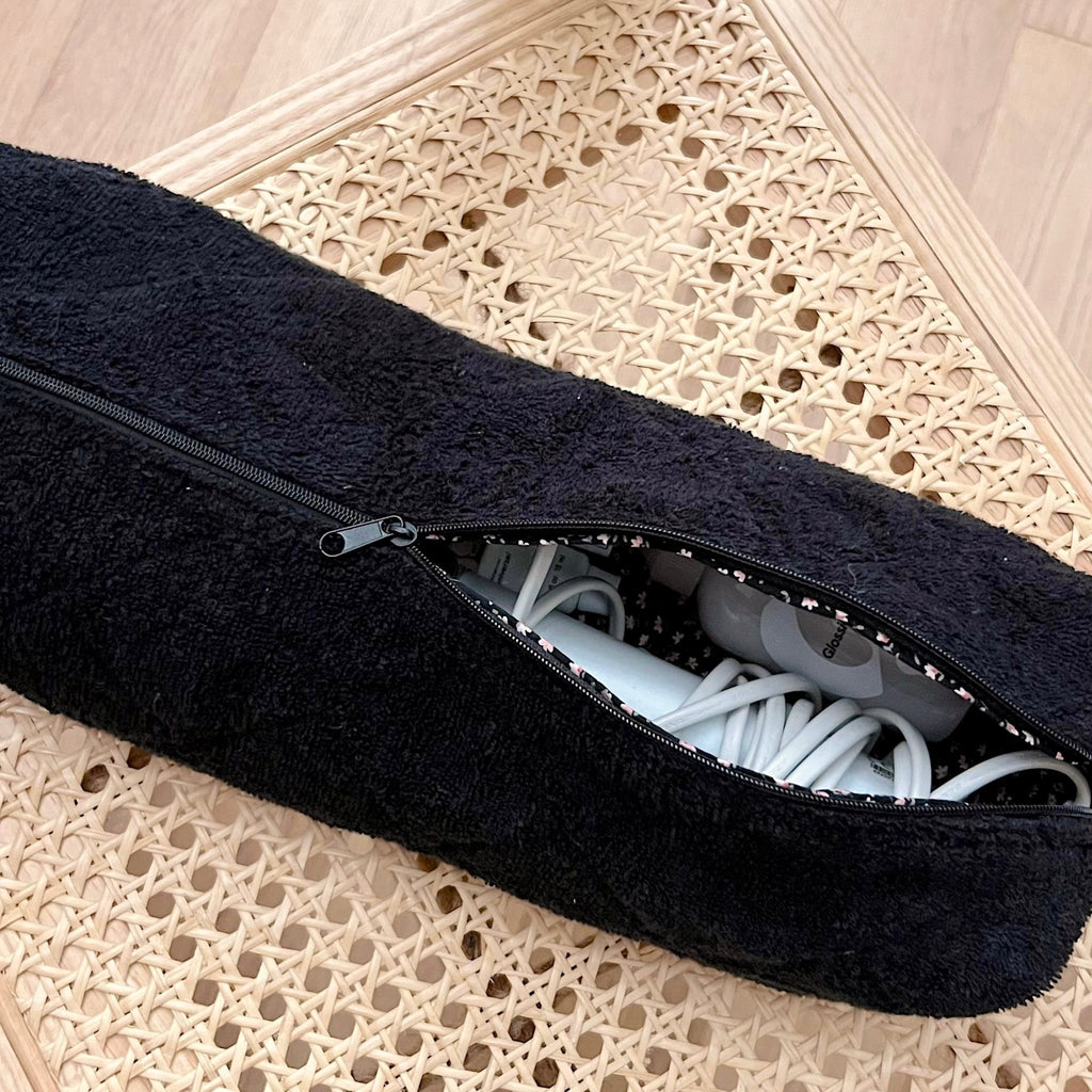 Dark terrycloth zip pouch, zipper open showing interior with pink ditsy floral lining