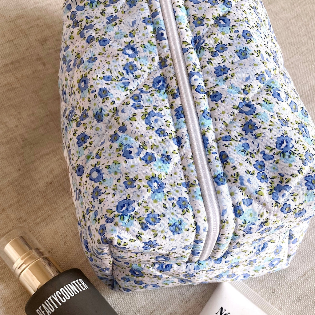 Close-up of blue floral zippered pouch fabric and zipper
