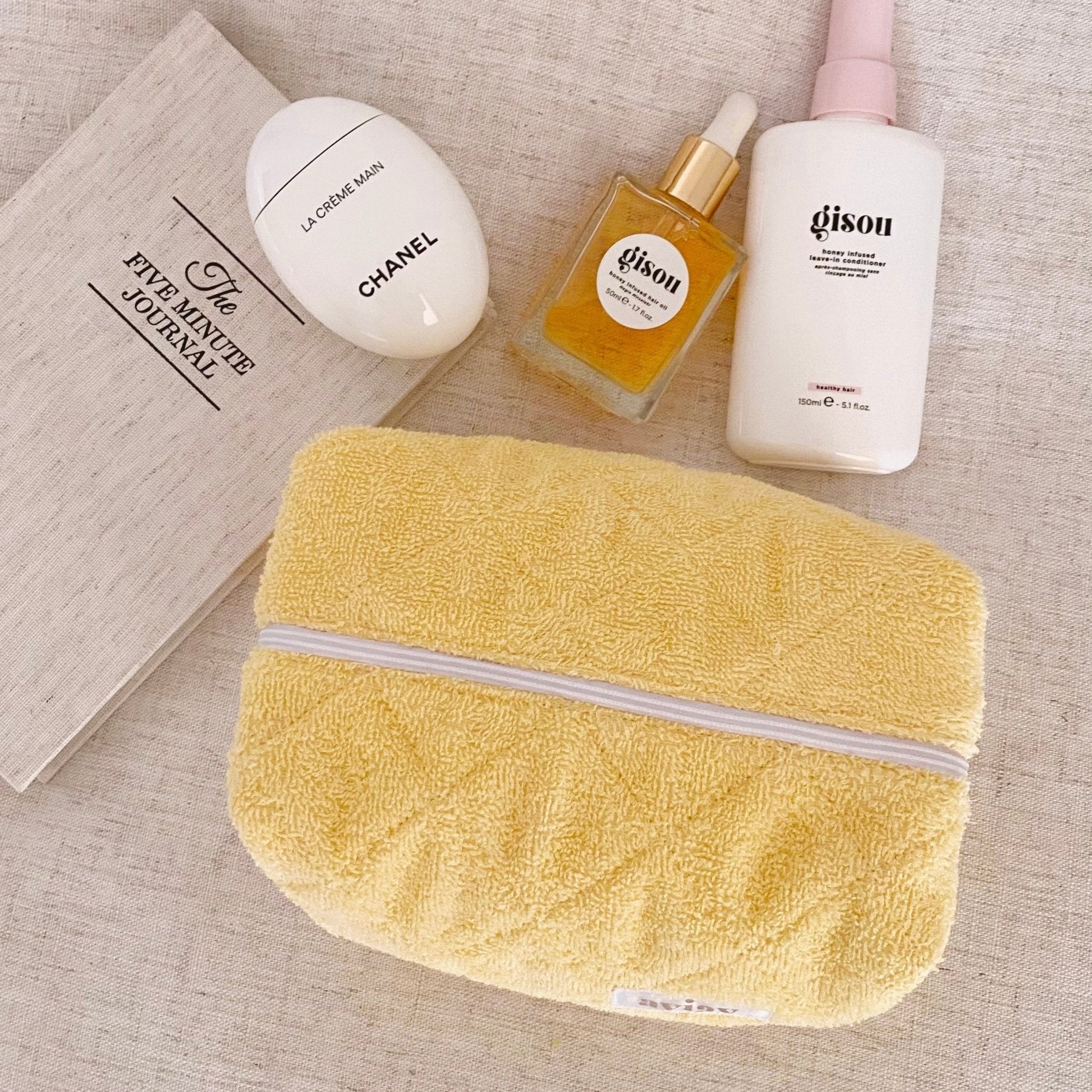 Butter yellow terrycloth folded zip pouch with white zipper trim