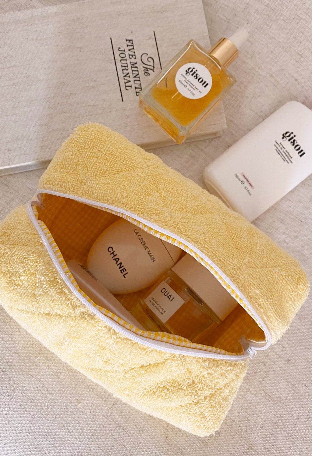 Butter yellow terrycloth pouch with open top and white zipper trim