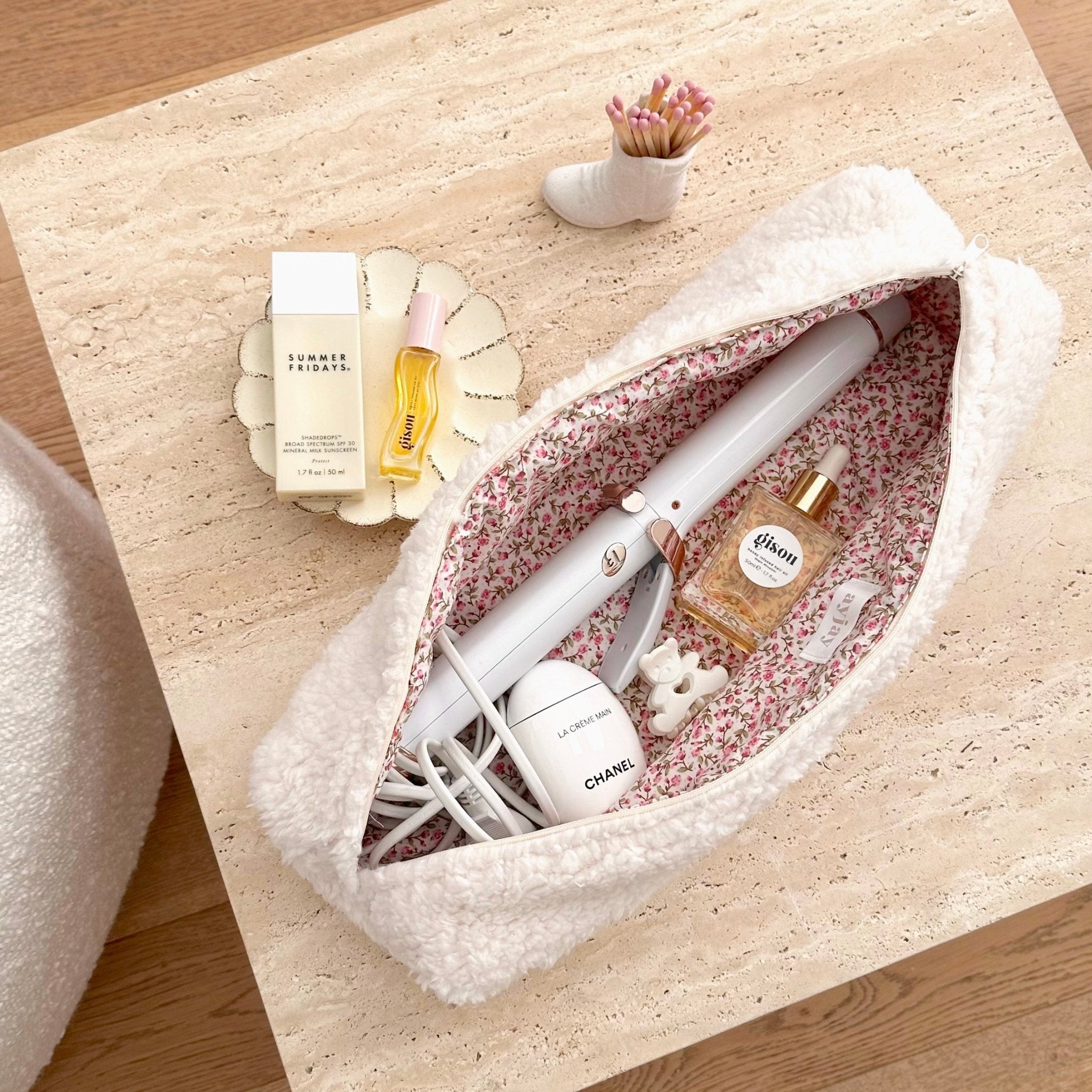 Cream teddy travel pouch open, pink floral interior with zip opening