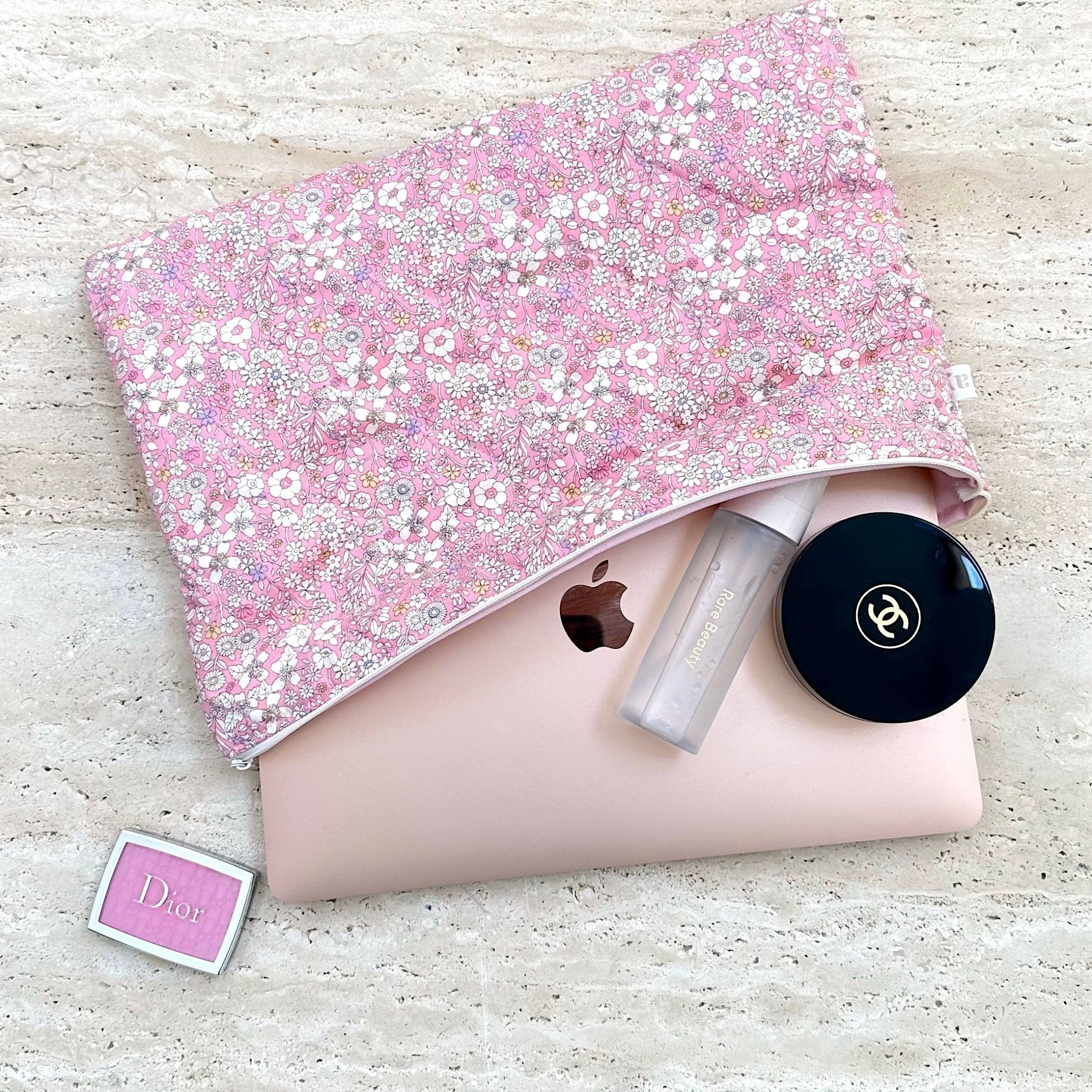 Folded pink floral fabric with small white flowers and light trim edging