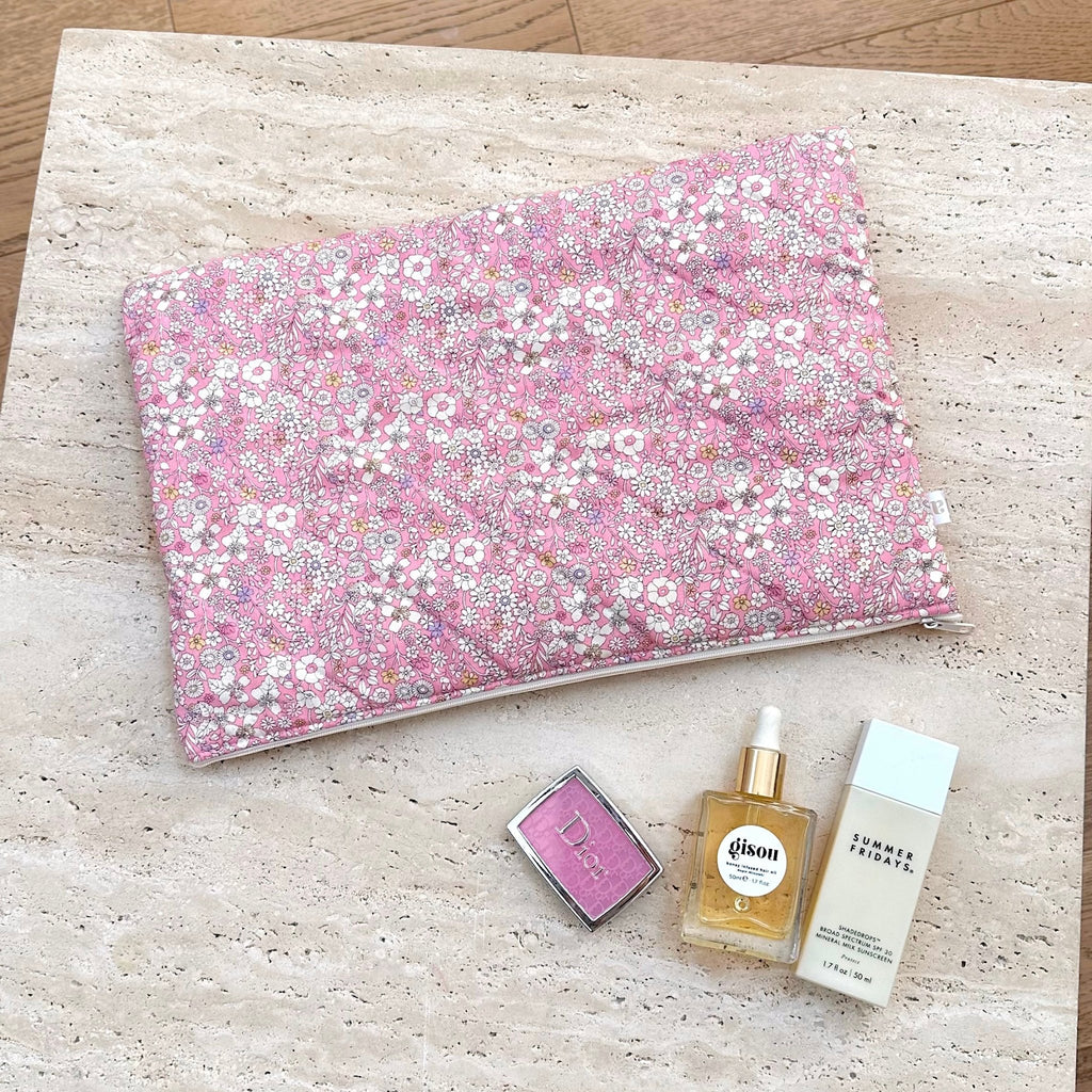 Pink floral fabric pouch/blanket with small white and yellow flower pattern
