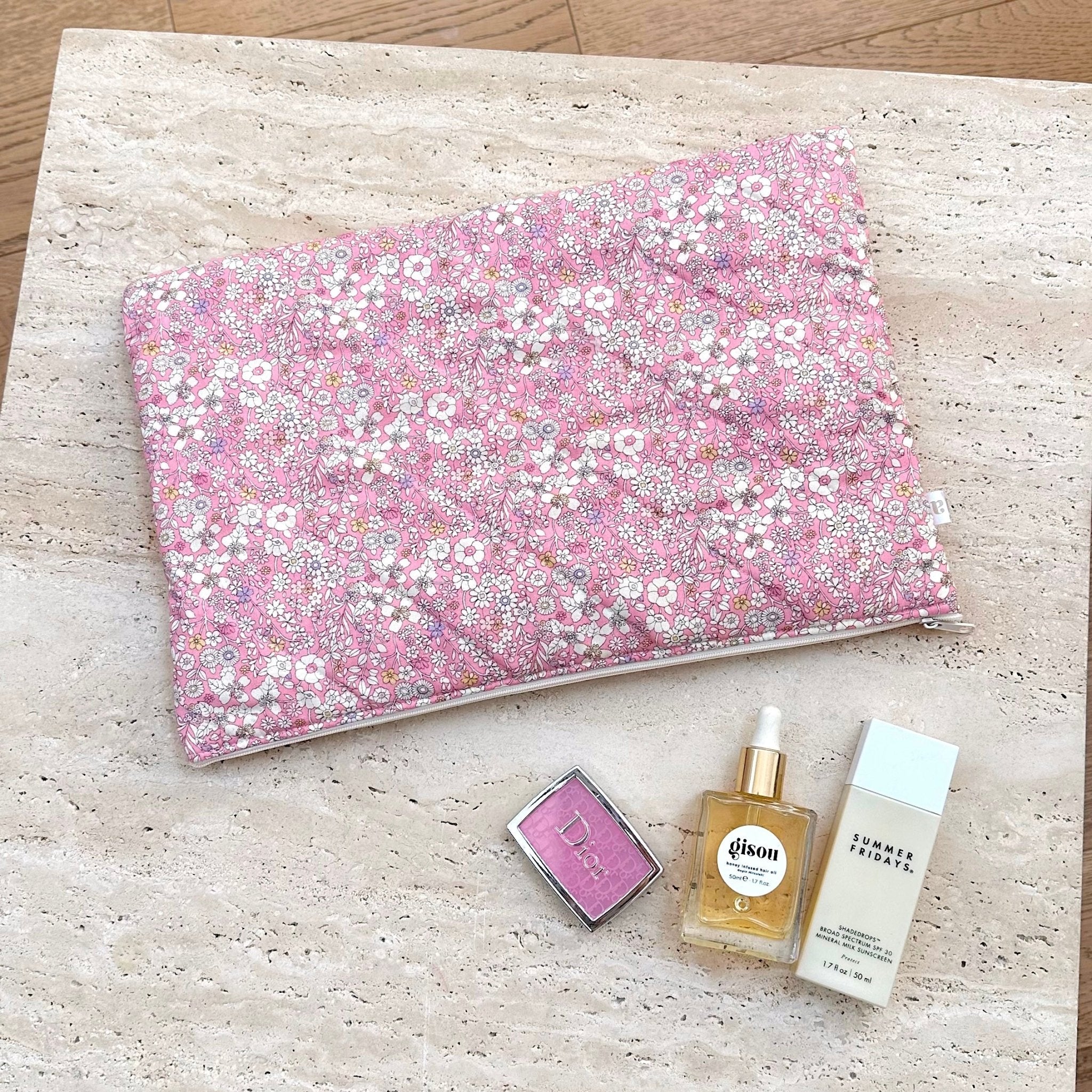 Pink floral fabric pouch/blanket with small white and yellow flower pattern