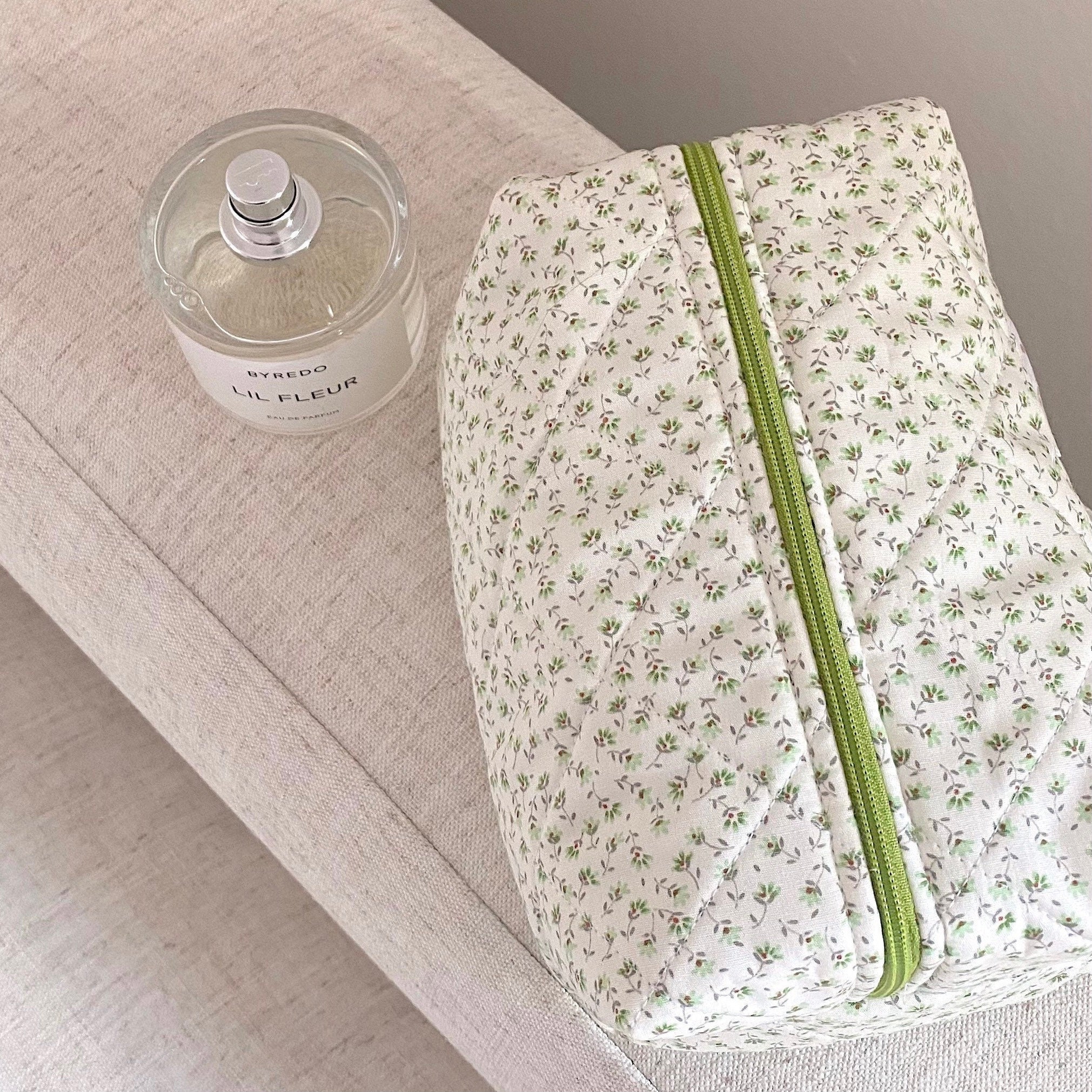Green ditsy floral zip pouch with bright green zipper, quilted fabric
