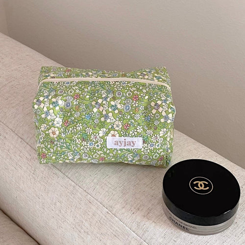 Green floral zip pouch with label on front, rectangular shape